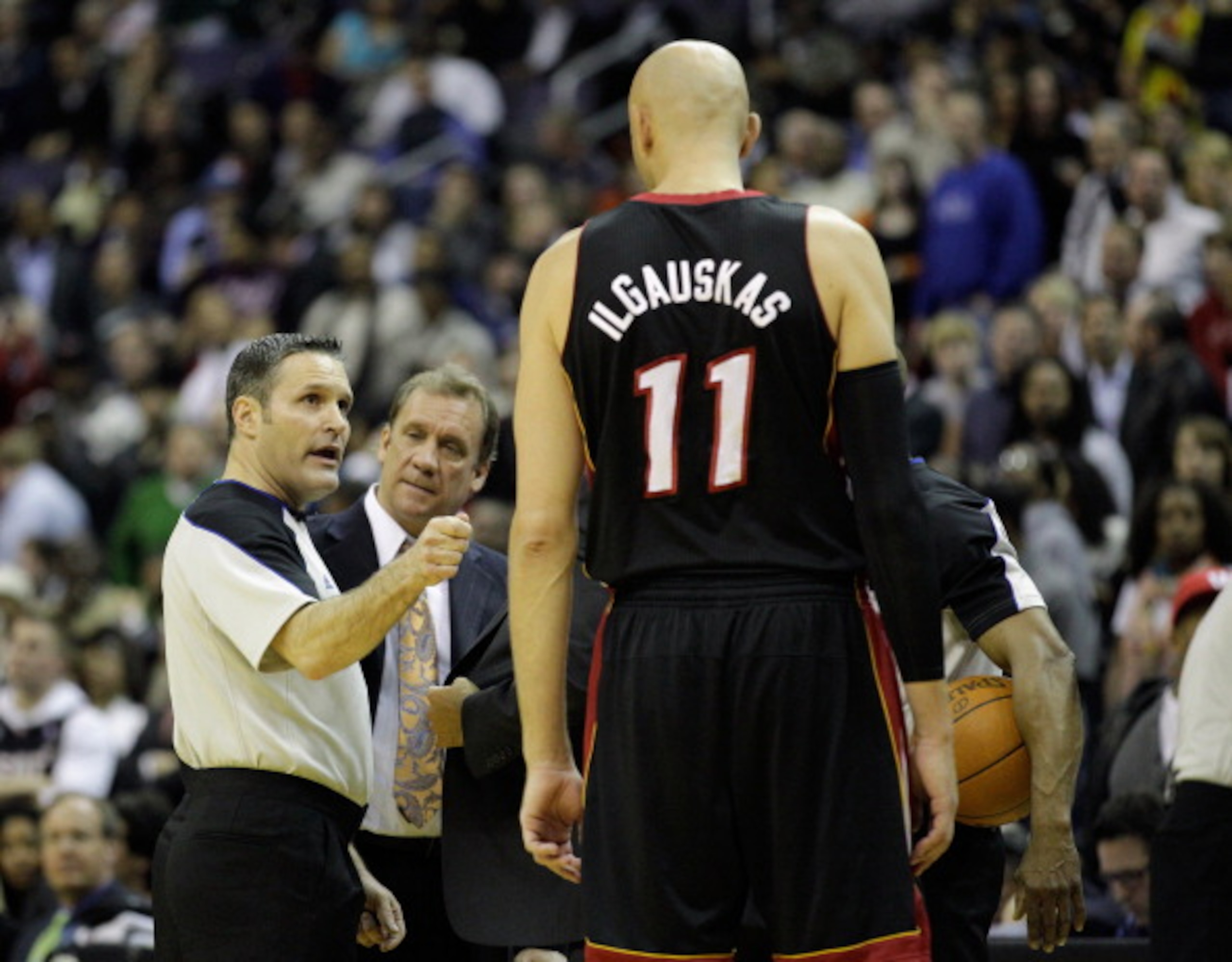 WASHINGTON, DC - MARCH 30: Referee Monty McCutchen #13 ejects Zydrunas Ilgauskas #11 of the Miami Heat after an altercation with John Wall #2 of the Washington Wizards during the first half at the Verizon Center on March 30, 2011 in Washington, DC. NOTE T