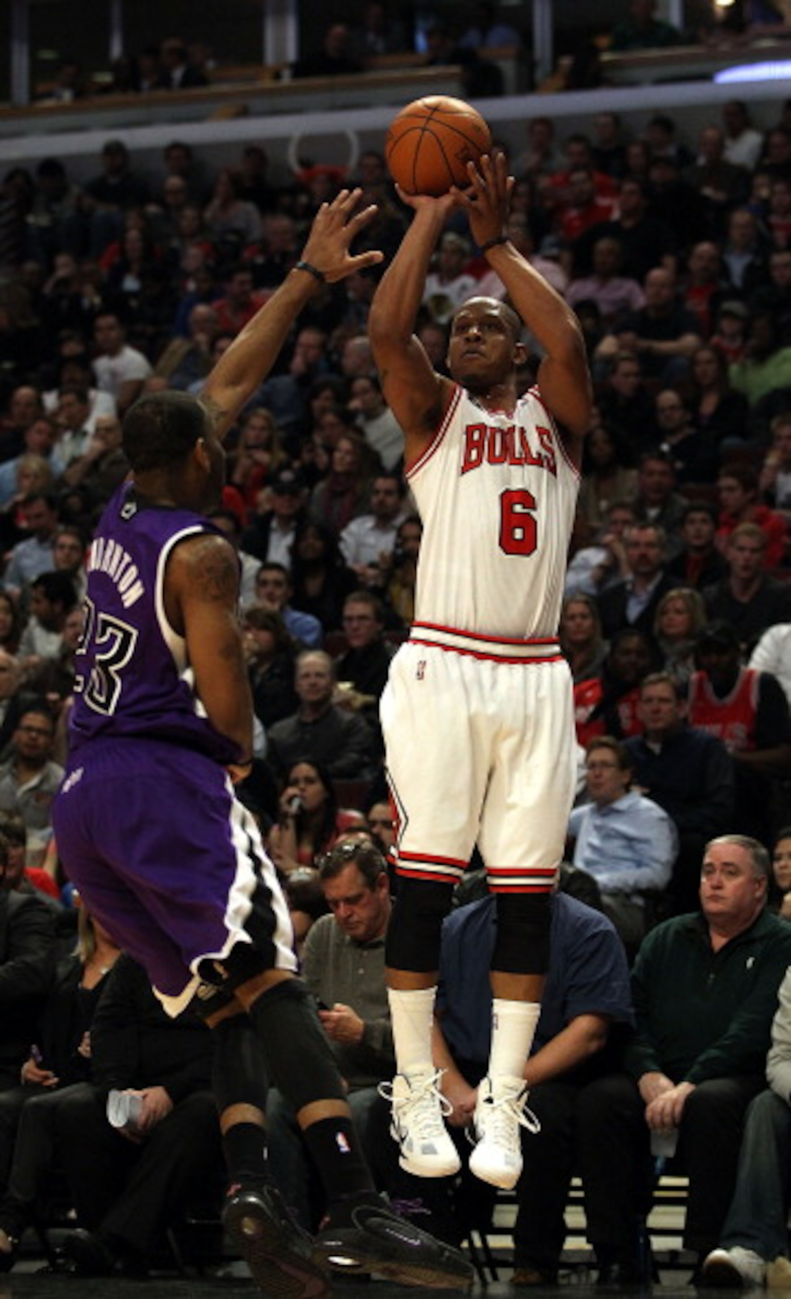 CHICAGO, IL - MARCH 21: Keith Bogans #6 of the Chicago Bulls puts up a shot over Marcus Thornton #23 of the Sacramento Kings at the United Center on March 21, 2011 in Chicago, Illinois. The Bulls defeated the Kings 132-92. NOTE TO USER: User expressly ack