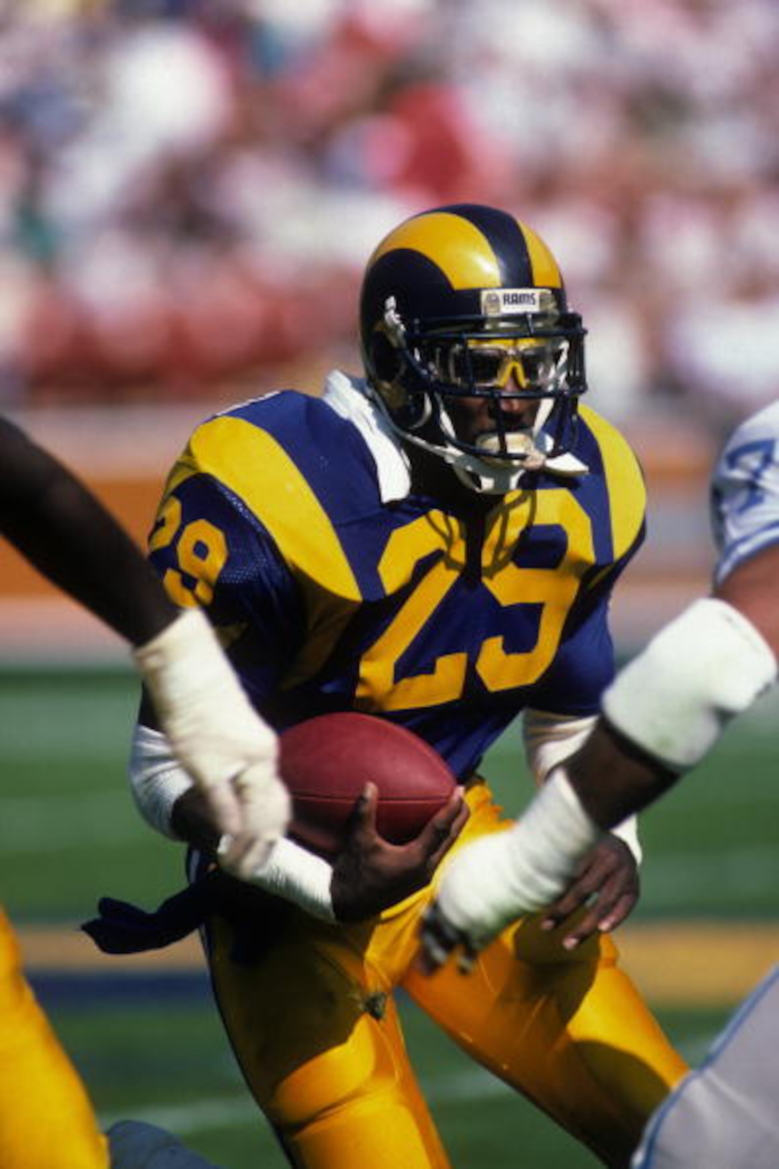 ANAHEIM, CA - OCTOBER 19:  Running back Eric Dickerson #28 of the Los Angeles Rams looks to make a move with the ball during the game against the Detroit Lions at Anaheim Stadium on October 19, 1986 in Anaheim, California.   The Rams won 14-10. (Photo by
