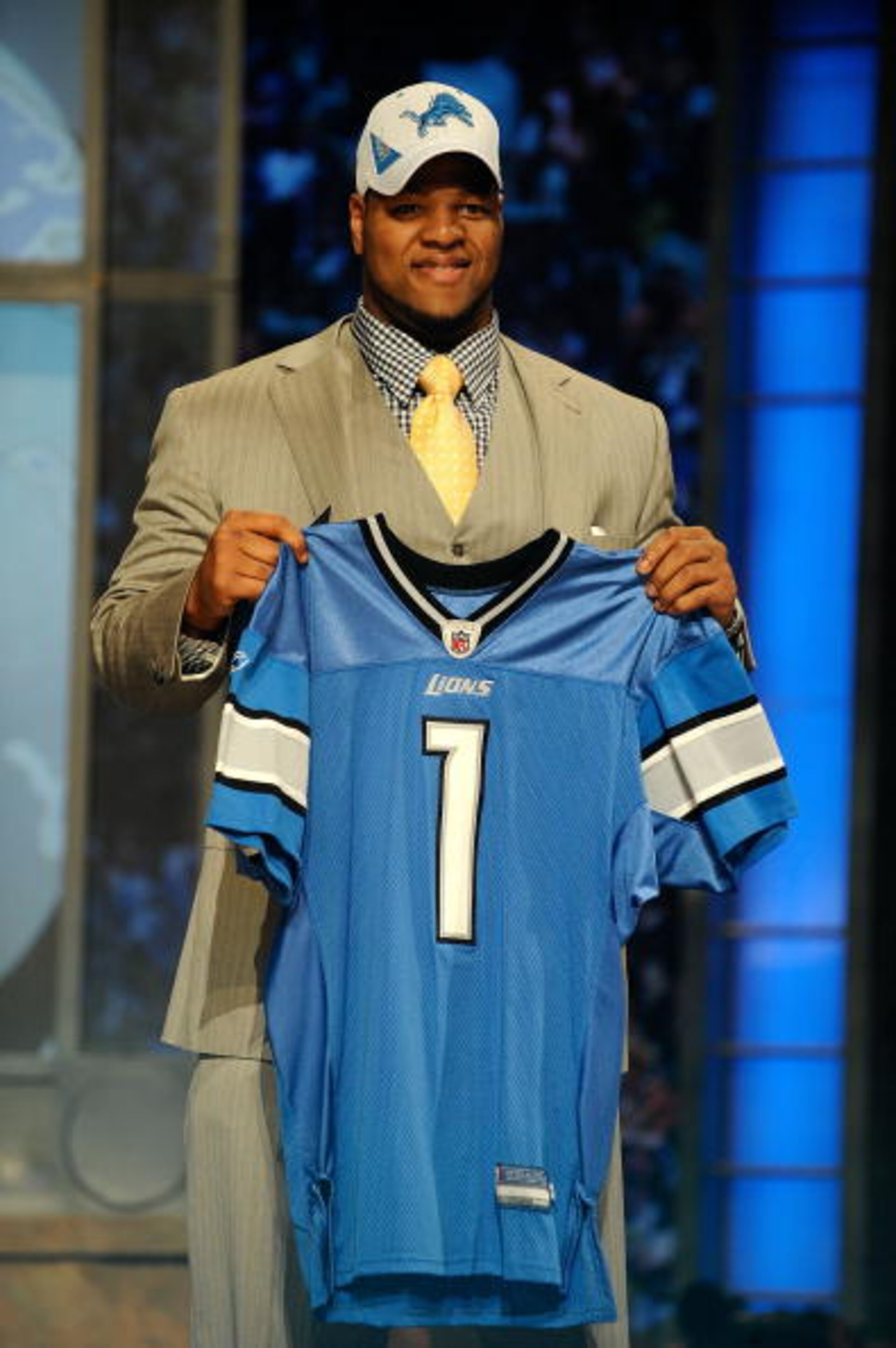 NEW YORK - APRIL 22:  Ndamukong Suh from the Nebraska Cornhuskers holds up a Detroit Lions jersey after Suh was selected by the Lions number 2 overall during the first round of the 2010 NFL Draft at Radio City Music Hall on April 22, 2010 in New York City