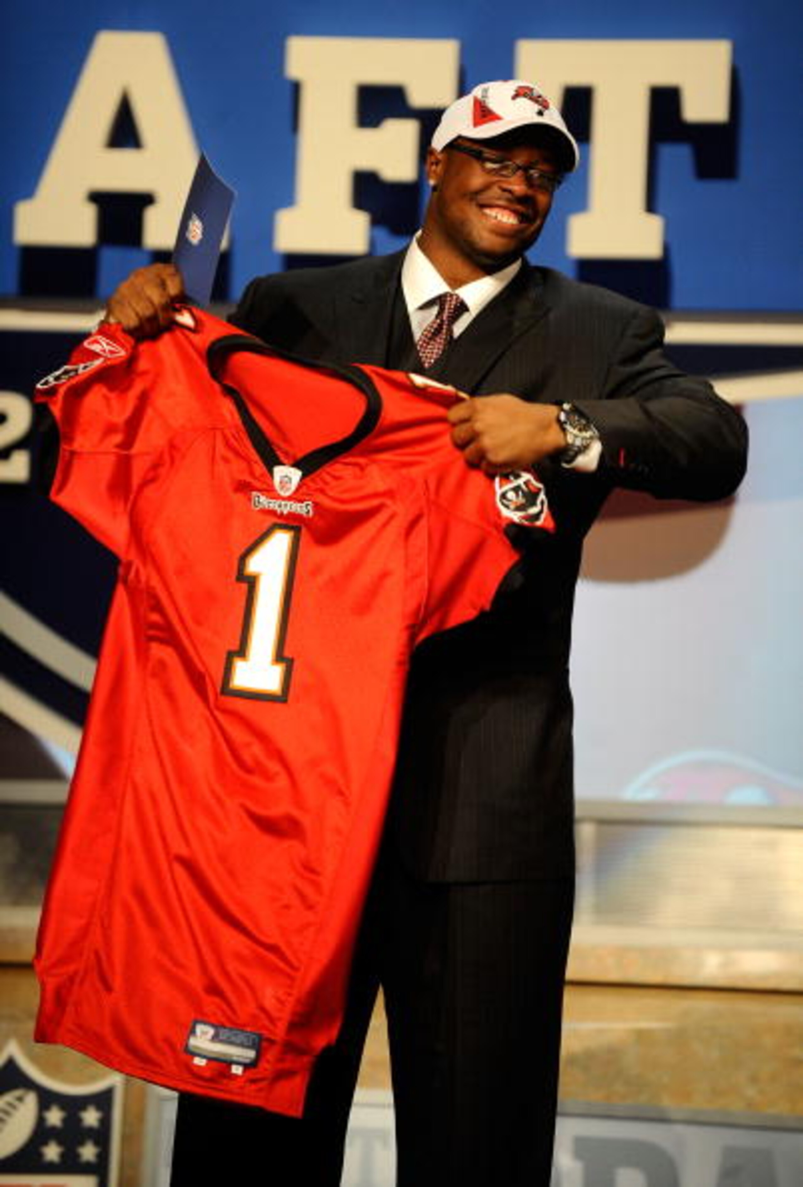 NEW YORK - APRIL 22:  Gerald McCoy (R) of the Oklahoma Sooners celebrates as he holds a Tampa Bay Buccaneers jersey after he was picked third overall by Tampa Bay during the 2010 NFL Draft at Radio City Music Hall on April 22, 2010 in New York City.  (Pho