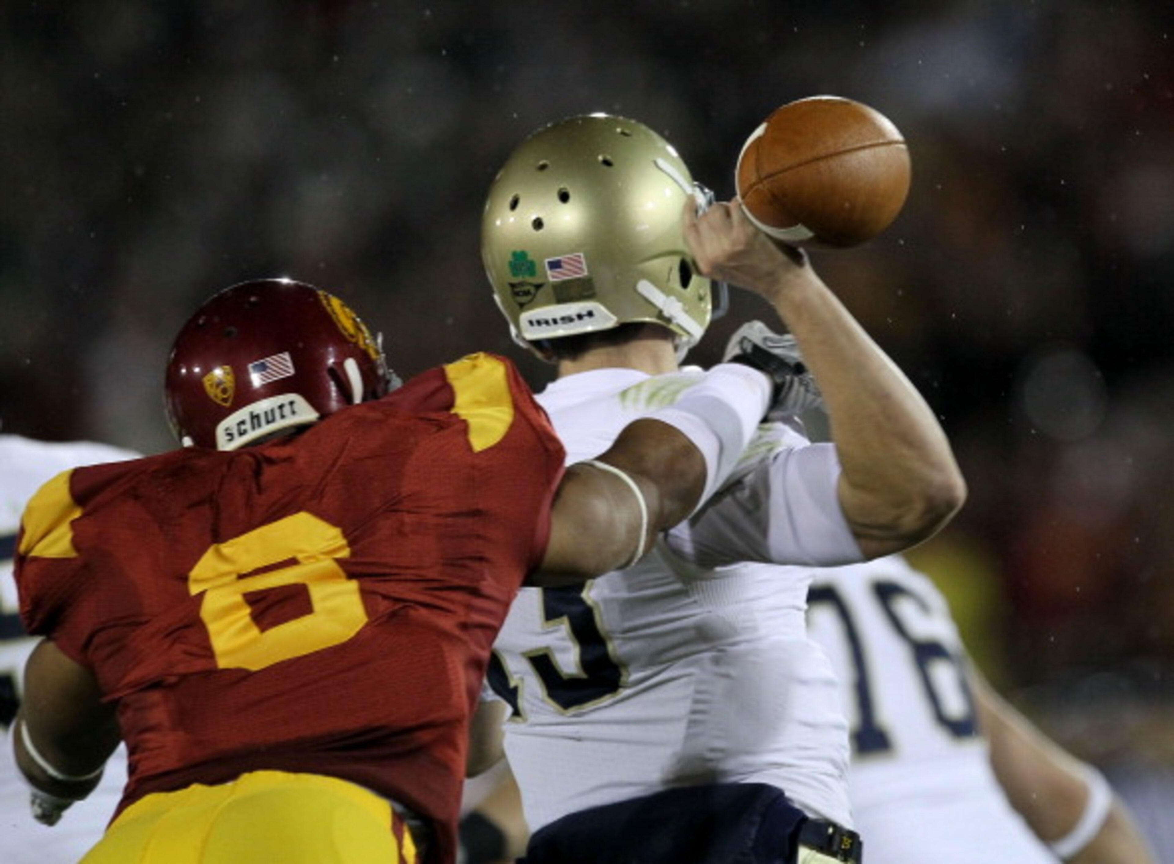 LOS ANGELES - NOVEMBER 27:  Defensive end Nick Perry #6 of the USC Trojans forces a fumble by quarterback Tommy Rees #13 of the Notre Dame Fighting Irish to set up USC's touchdown at the Los Angeles Memorial Coliseum on November 27, 2010 in Los Angeles, C