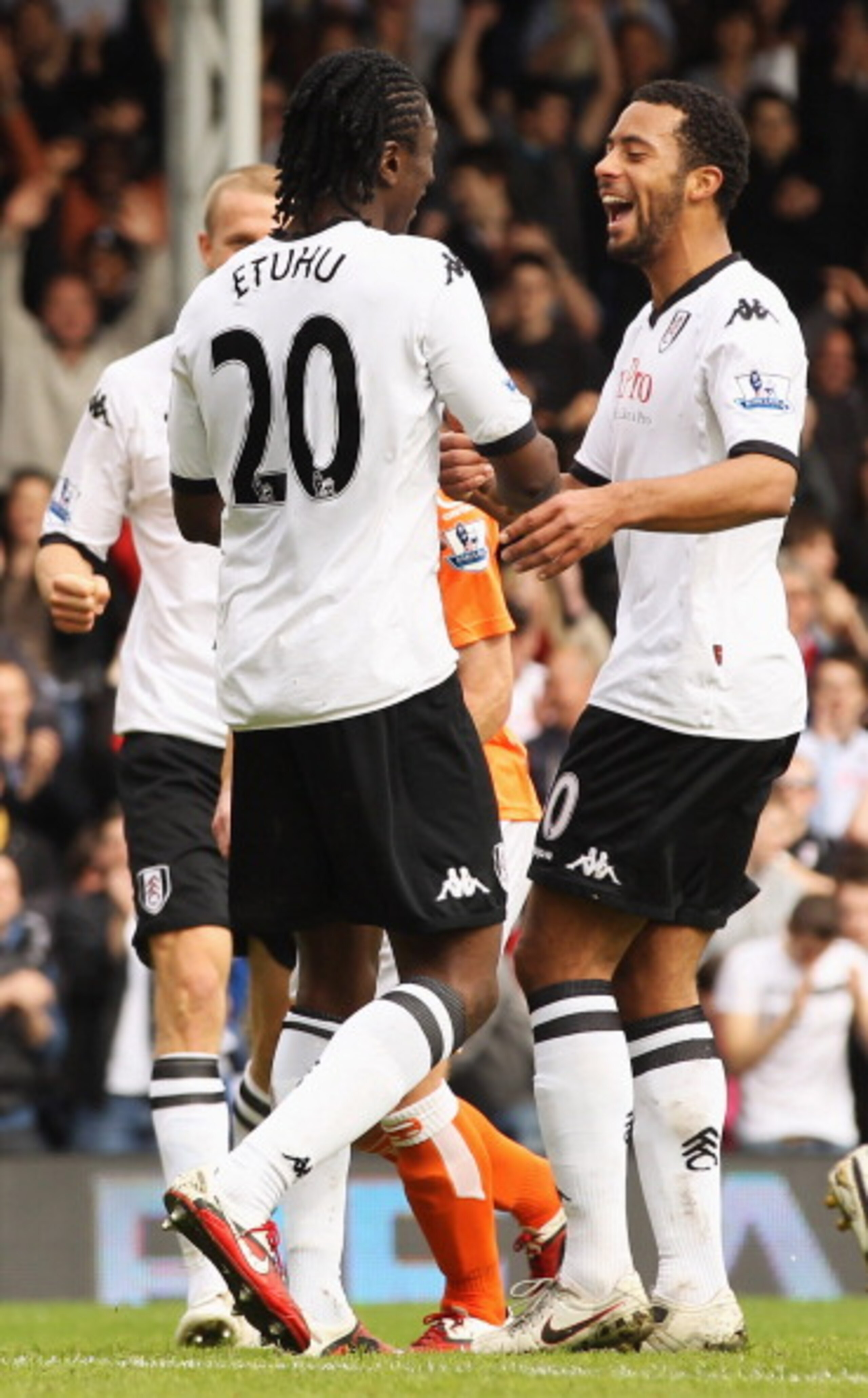 LONDON, ENGLAND - APRIL 03: Dickson Etuhu of Fulham (20) is congratulated by team mate Moussa Dembele as he scores their third goal during the Barclays Premier League match between Fulham and Blackpool at Craven Cottage on April 3, 2011 in London, Englan LONDON, ENGLAND - APRIL 03: Dickson Etuhu of Fulham (20) is congratulated by team mate Moussa Dembele as he scores their third goal during the Barclays Premier League match between Fulham and Blackpool at Craven Cottage on April 3, 2011 in London, Englan