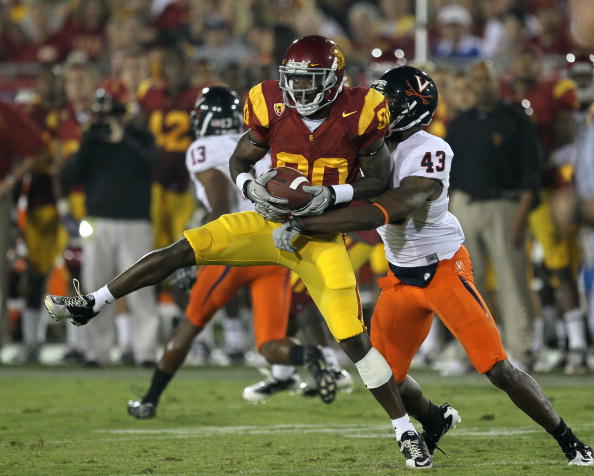 LOS ANGELES, CA - SEPTEMBER 11:  Wide receiver Brandon Carswell #80 of the USC Trojans makes a catch in front of cornerback Mike Parker #43 of the Virginia Cavaliers at Los Angeles Memorial Coliseum on September 11, 2010 in Los Angeles, California. USC wo