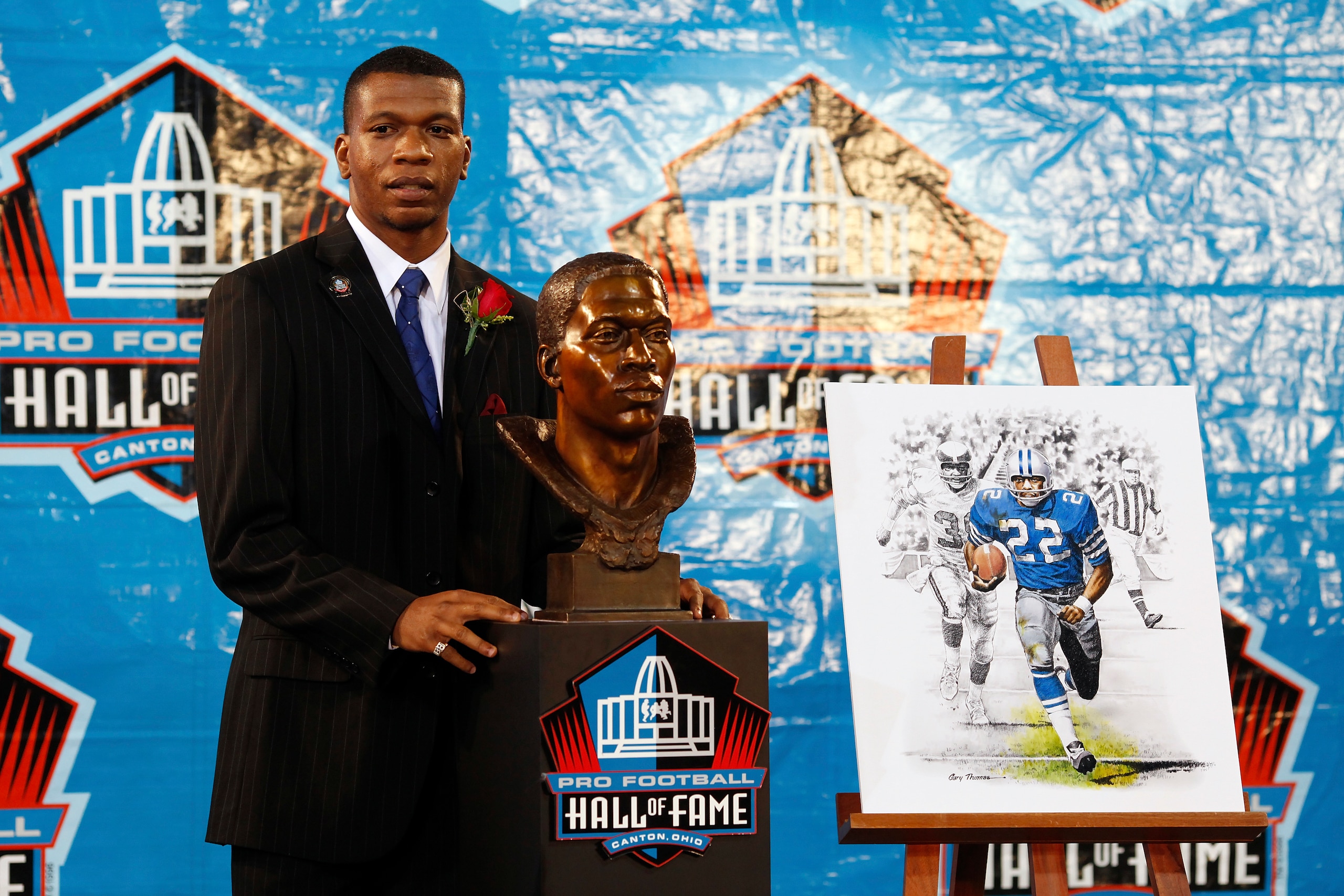 CANTON, OH - AUGUST 8: Bob Hayes Jr. poses with the bust of his late father Bob Sr. at his induction into the Pro Football Hall of Fame during the 2009 enshrinement ceremony at Fawcett Stadium on August 8, 2009 in Canton, Ohio. (Photo by Joe Robbins/Getty
