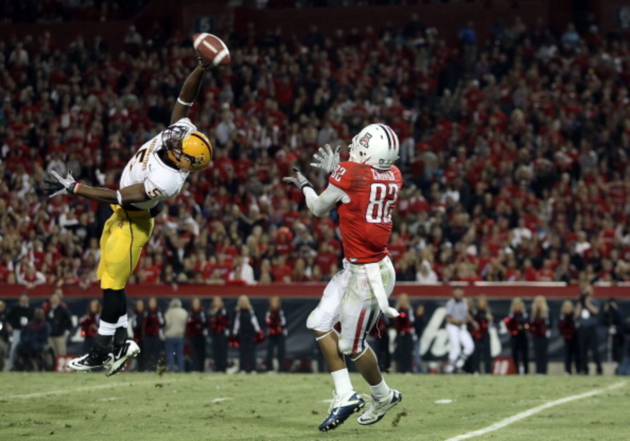 TUCSON, AZ - DECEMBER 02:  Wide receiver Juron Criner #82 of the Arizona Wildcats catches a 52 yard touchdown reception past LeQuan Lewis #5 of the Arizona State Sun Devils during the college football game at Arizona Stadium on December 2, 2010 in Tucson,