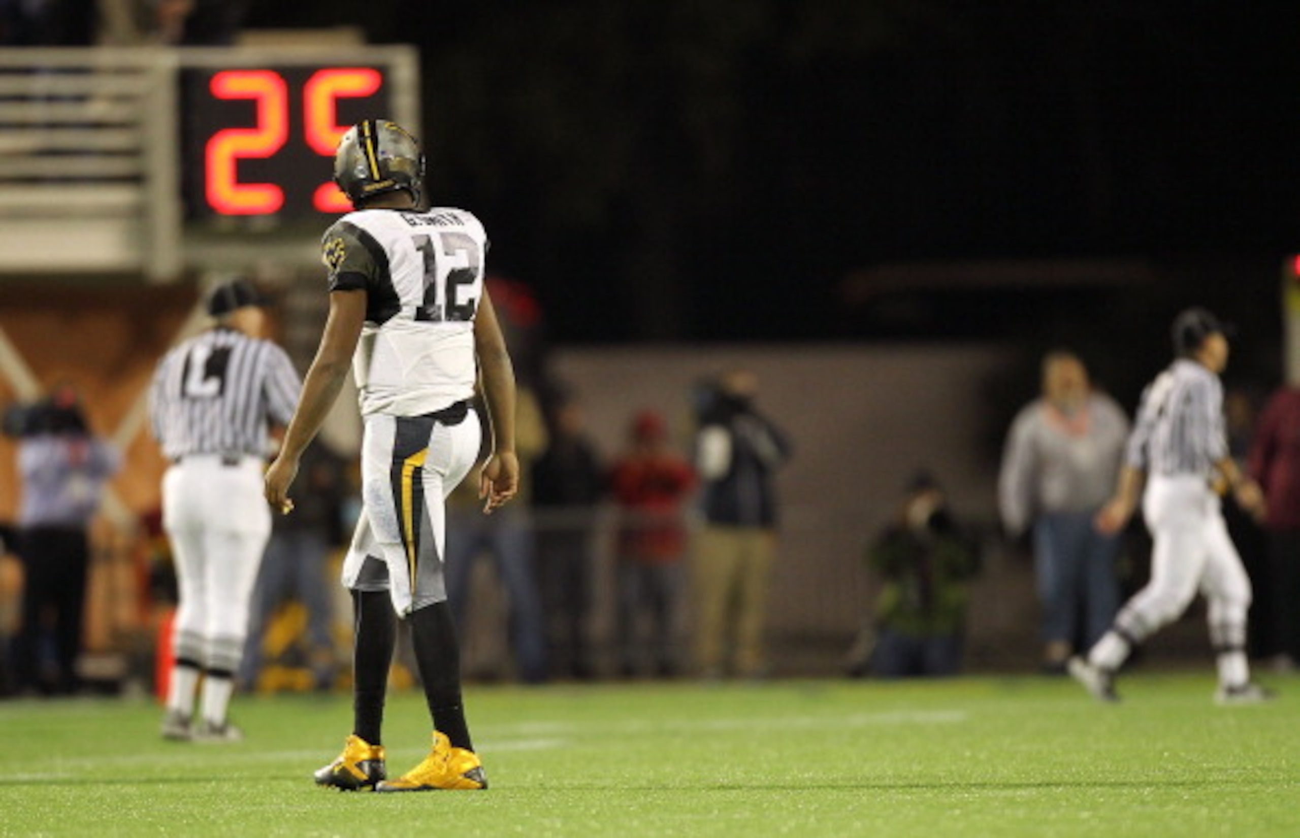 ORLANDO, FL - DECEMBER 28:  Geno Smith #12 of the West Virginia Mountineers walks off the field after an interception during the Champs Sports Bowl against the North Carolina State Wolfpack at Florida Citrus Bowl Stadium on December 28, 2010 in Orlando, F