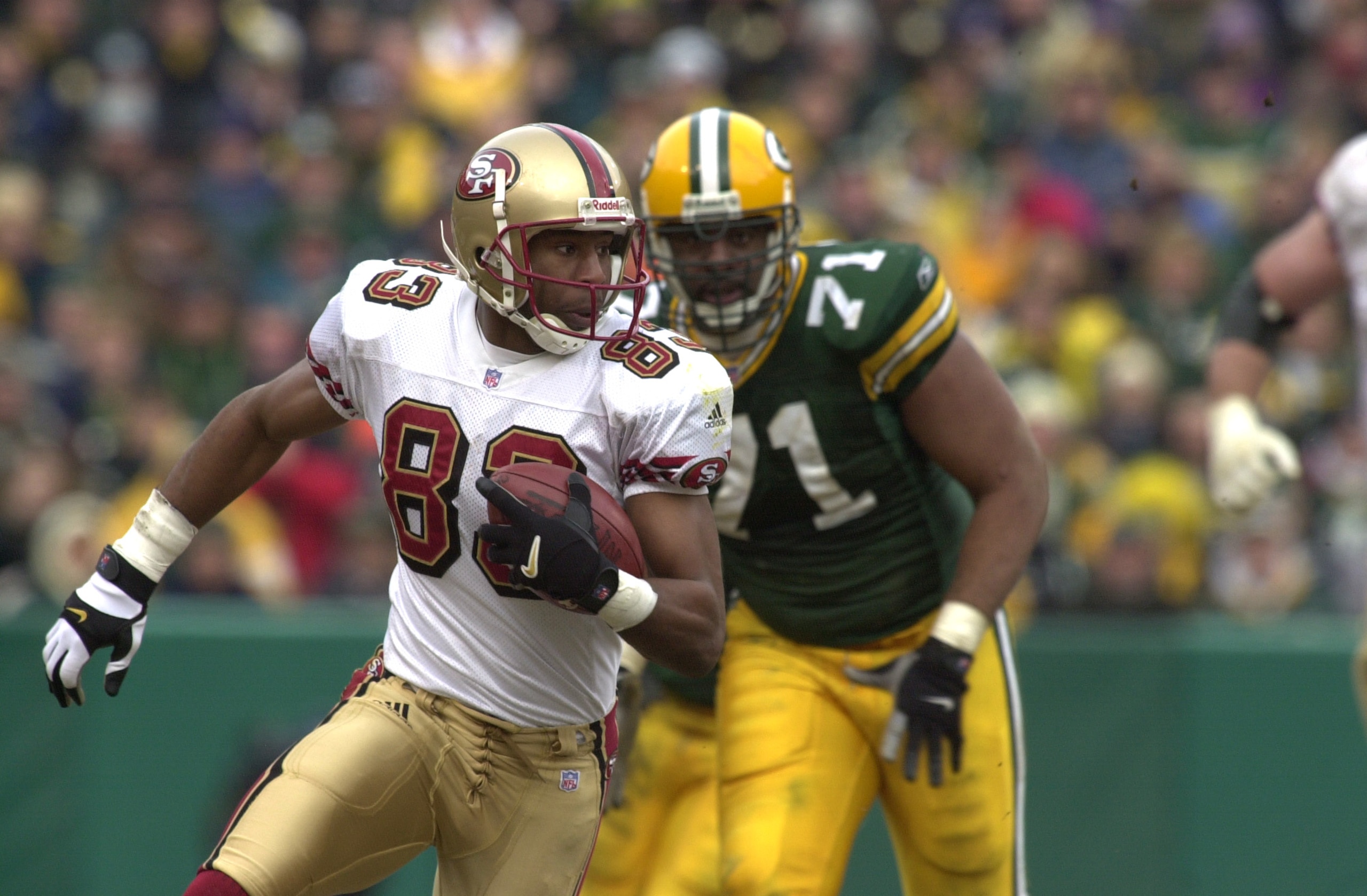 13 Jan 2002:  J. J. Stokes #83 of the San Francisco 49ers runs against the defense of Santana Dotson #71 of the Green Bay Packers during the NFC wild-card game at Lambeau Field in Green Bay, Wisconsin. The Packers won 25-15. DIGITAL IMAGE Mandatory Credit
