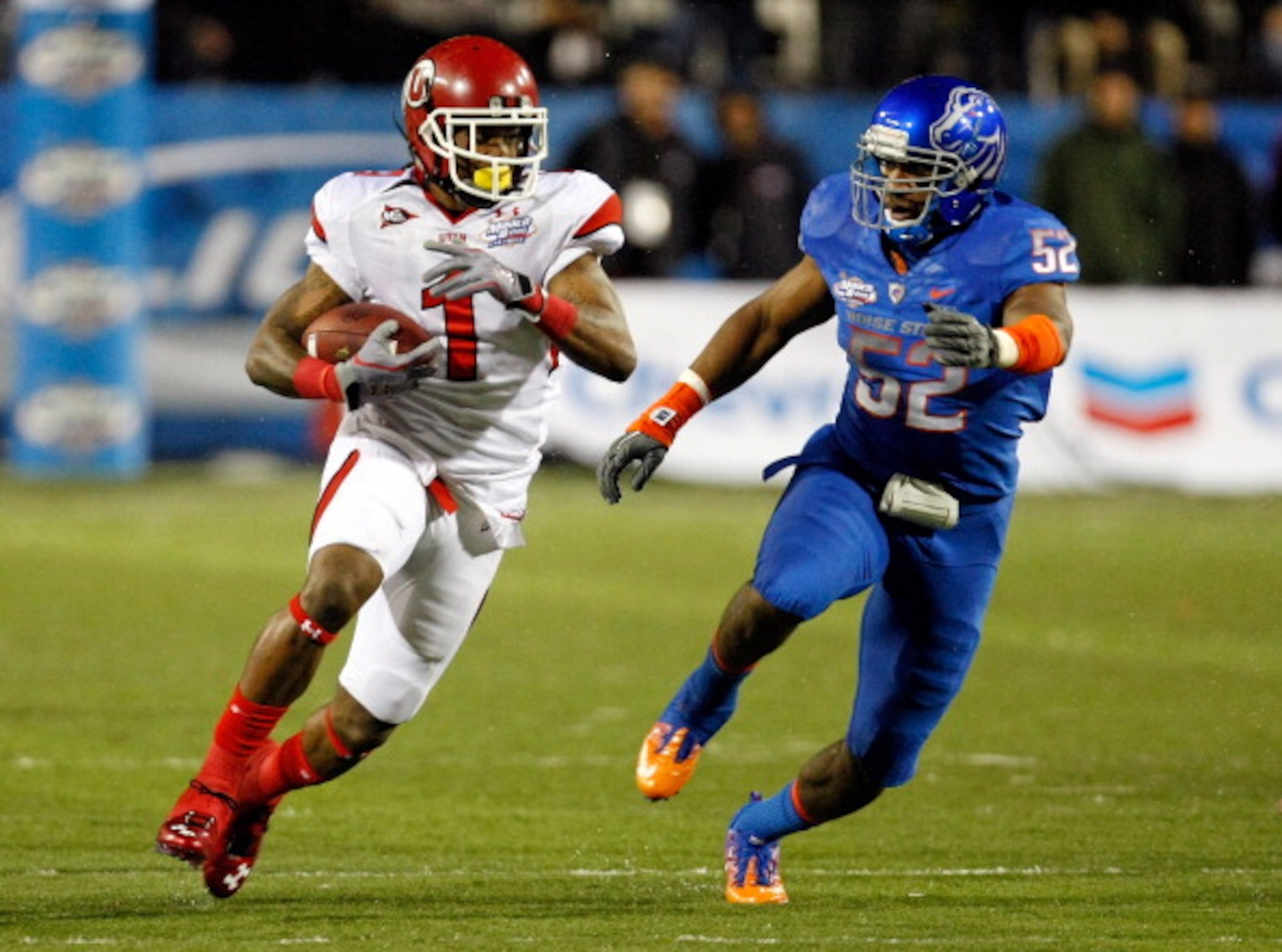 LAS VEGAS, NV - DECEMBER 22:  Shaky Smithson #1 of the Utah Utes runs for yardage against Derrell Acrey #52 of the Boise State Broncos during the MAACO Bowl Las Vegas at Sam Boyd Stadium December 22, 2010 in Las Vegas, Nevada. Boise State Won 26-3.  (Phot