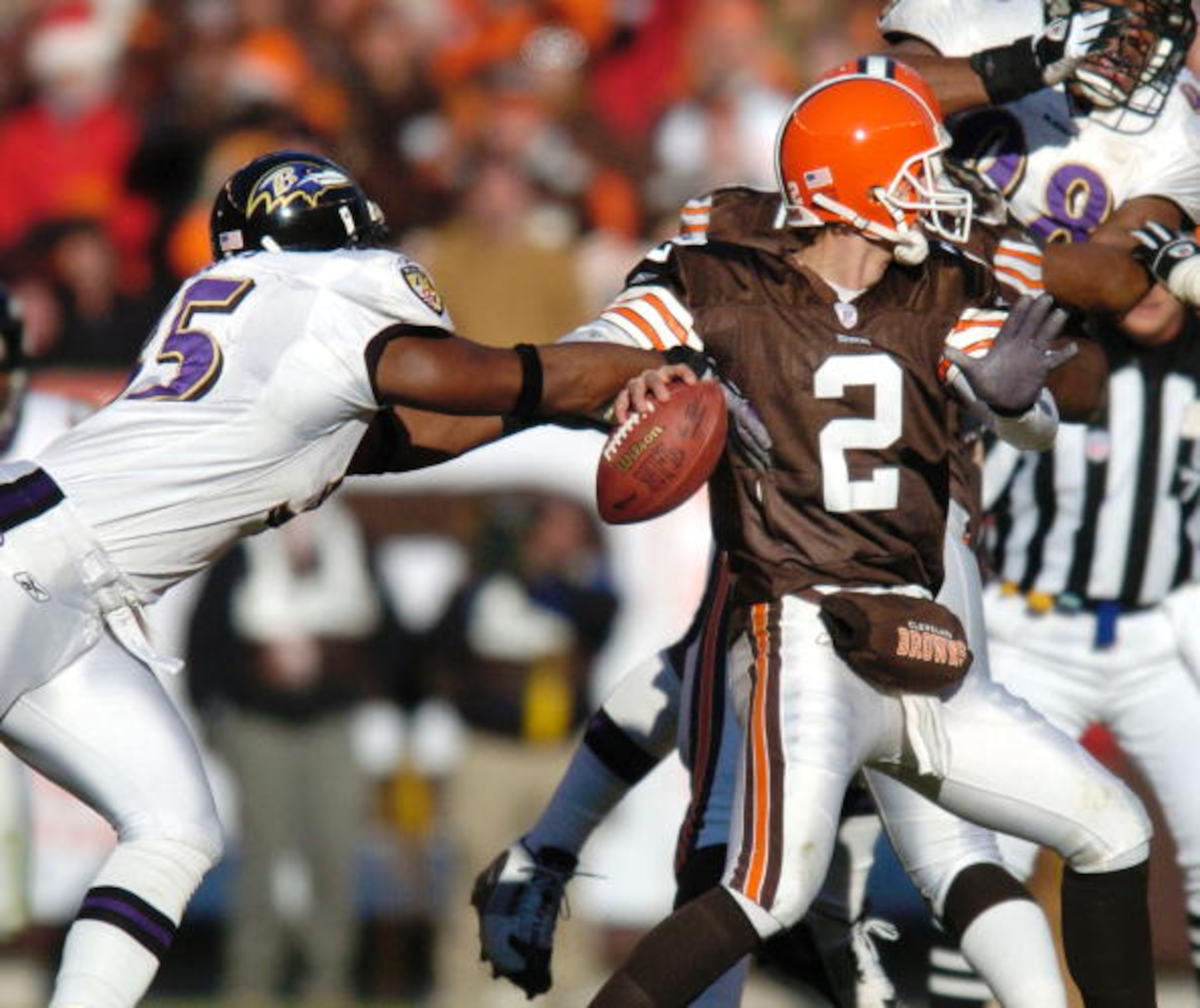 CLEVELAND, OH - DECEMBER 21:  Linebacker Terell Suggs #55 of the Baltimore Ravens strips the ball from quarterback Tim Couch #2 of the Cleveland Browns during the second quarter on December 21, 2003 at Cleveland Browns Stadium in Cleveland, Ohio. Suggs re