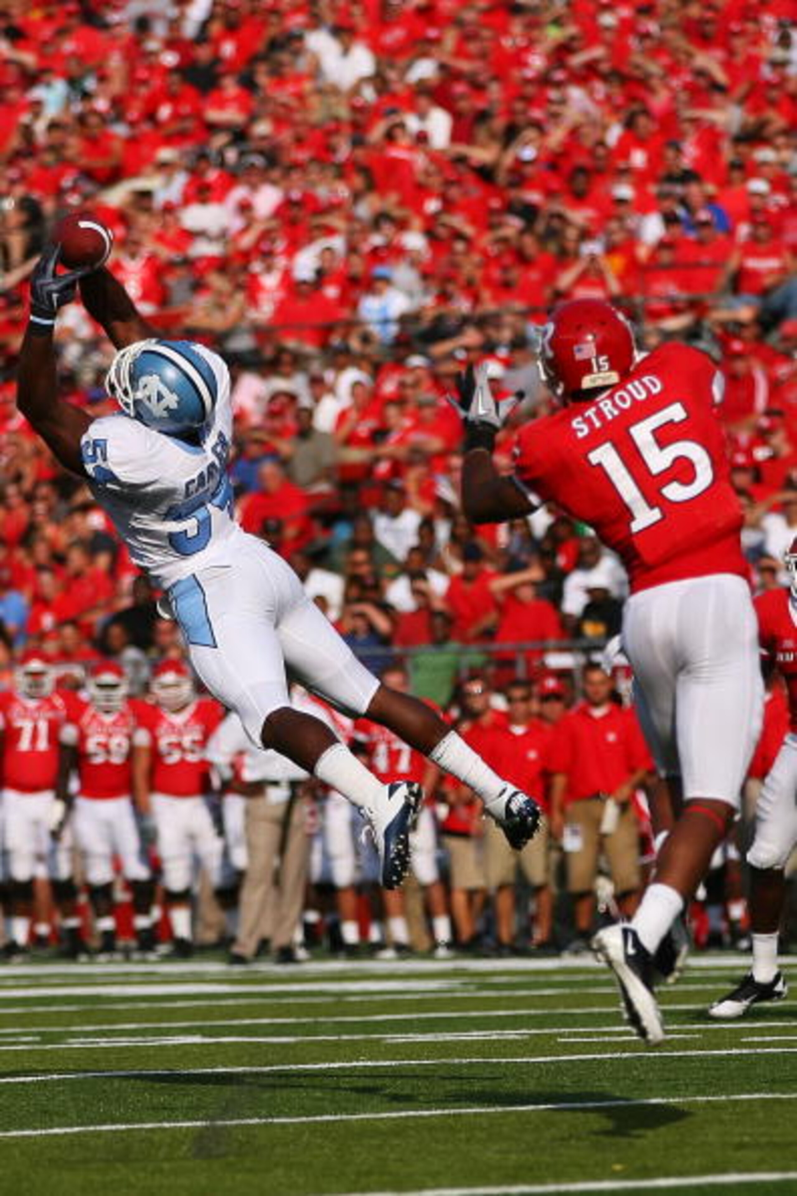 NEW BRUNSWICK, NJ - SEPTEMBER 25: Bruce Carter #54 of the North Carolina Tar Heels intercepts a pass intented for Keith Stroud #15 of the Rutgers Scarlet Knights during the second quarter at Rutgers Stadium on September 25, 2010 in New Brunswick, New Jers NEW BRUNSWICK, NJ - SEPTEMBER 25: Bruce Carter #54 of the North Carolina Tar Heels intercepts a pass intented for Keith Stroud #15 of the Rutgers Scarlet Knights during the second quarter at Rutgers Stadium on September 25, 2010 in New Brunswick, New Jers