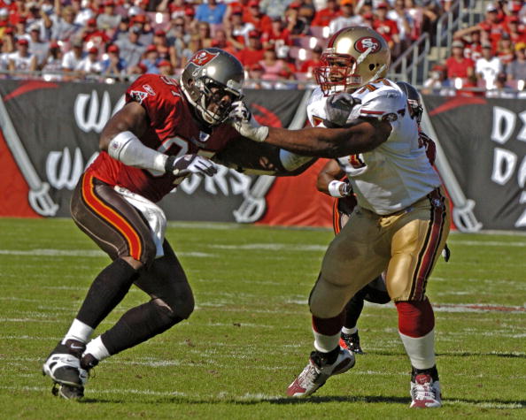 Tampa Bay Buccaneers defensive end Simeon Rice battles San francisco 49ers tackle Kwame Harris  at Raymond James Stadium in Tampa, Florida November 21, 2004.  The  Buccaneers defeated the  San Francisco 49ers 35 to 3.  (Photo by Al Messerschmidt/Getty Ima
