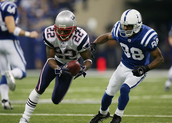 INDIANAPOLIS - JANUARY 21:  Asante Samuel #22 of the New England Patriots runs back an interception for a touchdown in front of Marvin Harrison #88 of the Indianapolis Colts during the second quarter against the Indianapolis Colts during the AFC Champions