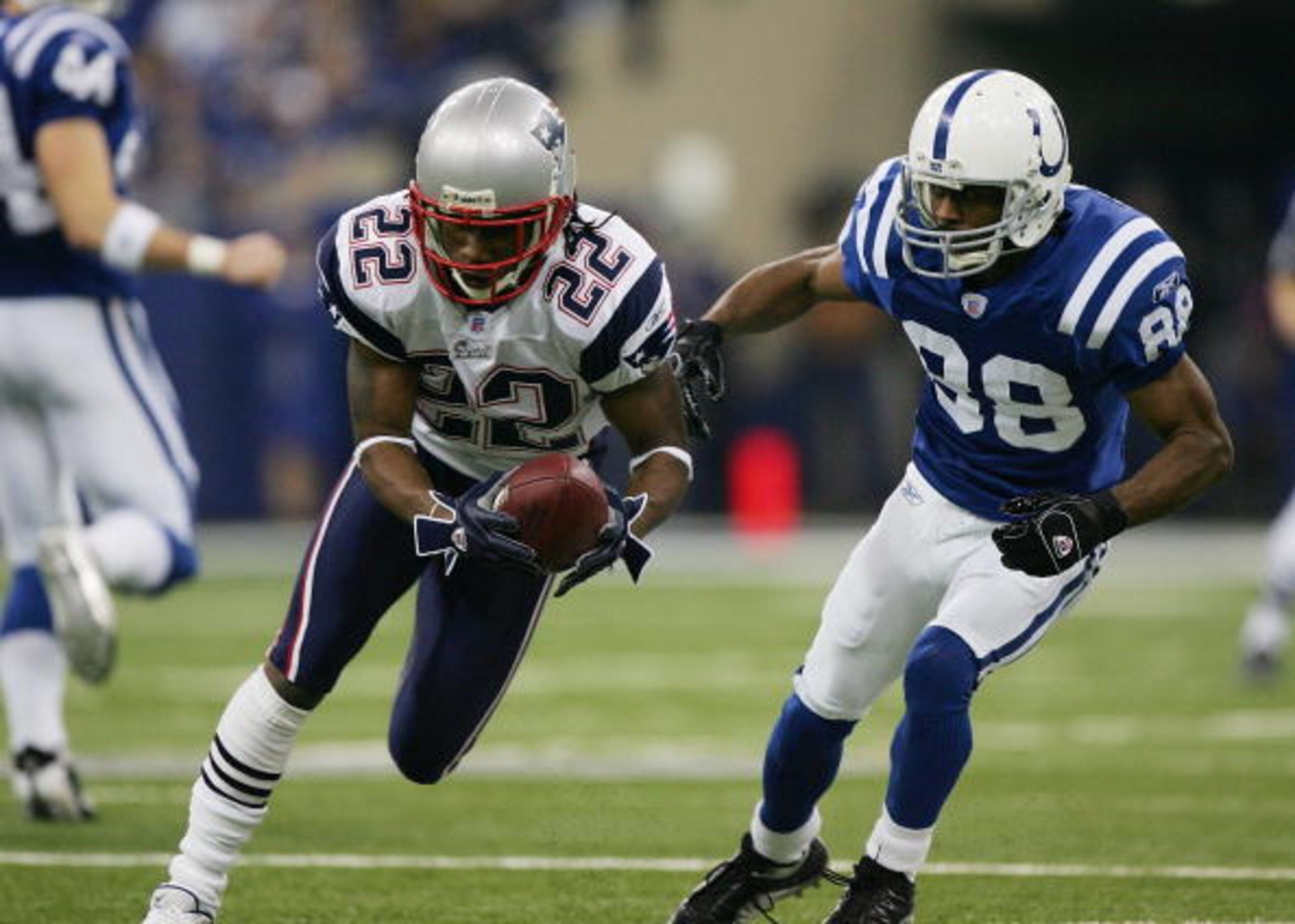 INDIANAPOLIS - JANUARY 21: Asante Samuel #22 of the New England Patriots runs back an interception for a touchdown in front of Marvin Harrison #88 of the Indianapolis Colts during the second quarter against the Indianapolis Colts during the AFC Champions INDIANAPOLIS - JANUARY 21: Asante Samuel #22 of the New England Patriots runs back an interception for a touchdown in front of Marvin Harrison #88 of the Indianapolis Colts during the second quarter against the Indianapolis Colts during the AFC Champions