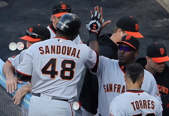 LOS ANGELES, CA - APRIL 03:  Pablo Sandoval #48 of the San Francisco Giants receives high fives in the dugout after hitting a solo home run in the second inning against the Los Angeles Dodgers at Dodger Stadium on April 3, 2011 in Los Angeles, California.