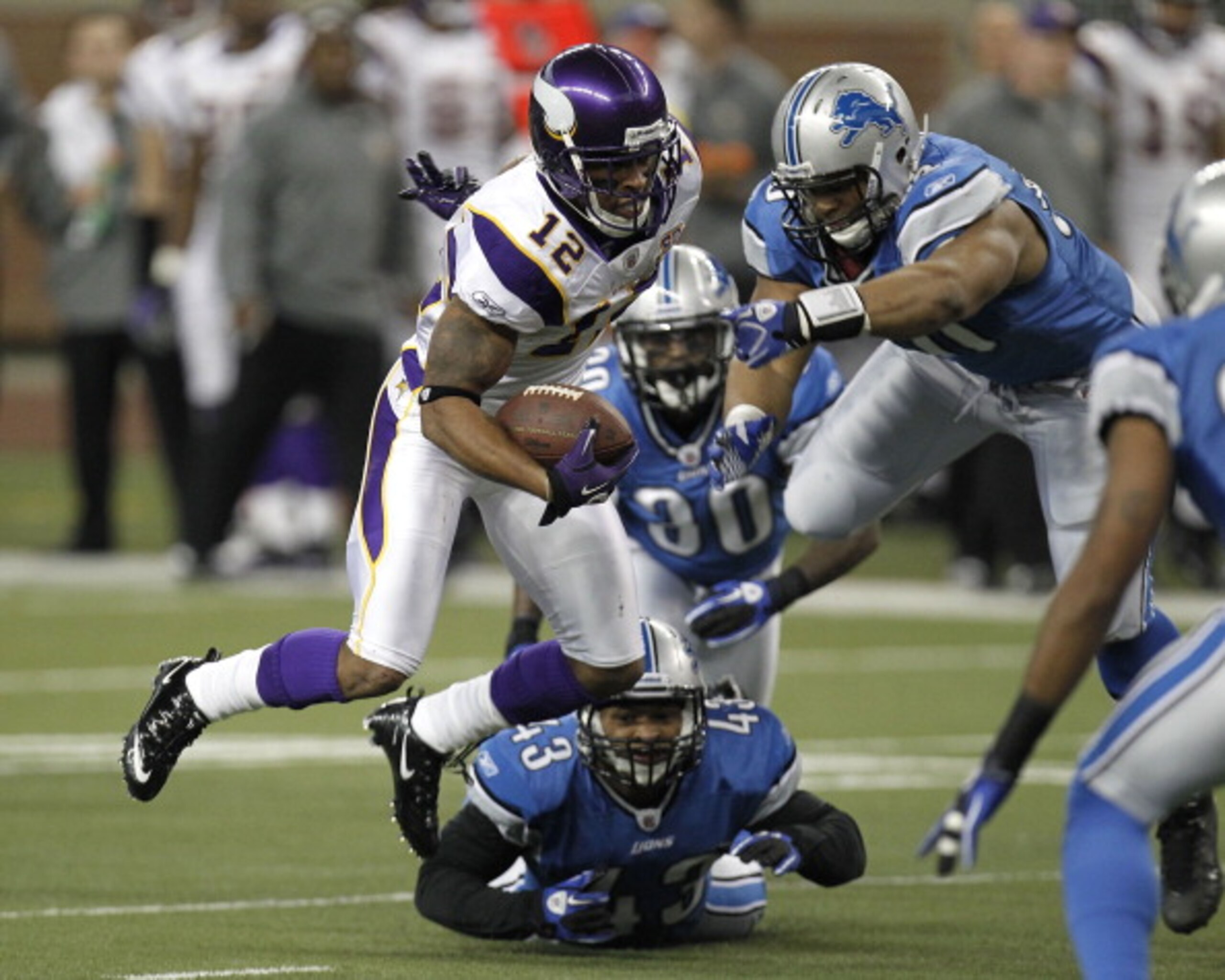 DETROIT, MI - JANUARY 02: Percy Harvin #12 of the Minnesota Vikings tries to escape the tackles of Ndamukong Suh #90, Nathan Vasher #30 and Eric King #43 of the Detroit Lions at Ford Field on January 2, 2011 in Detroit, Michigan. (Photo by Gregory Shamus DETROIT, MI - JANUARY 02: Percy Harvin #12 of the Minnesota Vikings tries to escape the tackles of Ndamukong Suh #90, Nathan Vasher #30 and Eric King #43 of the Detroit Lions at Ford Field on January 2, 2011 in Detroit, Michigan. (Photo by Gregory Shamus