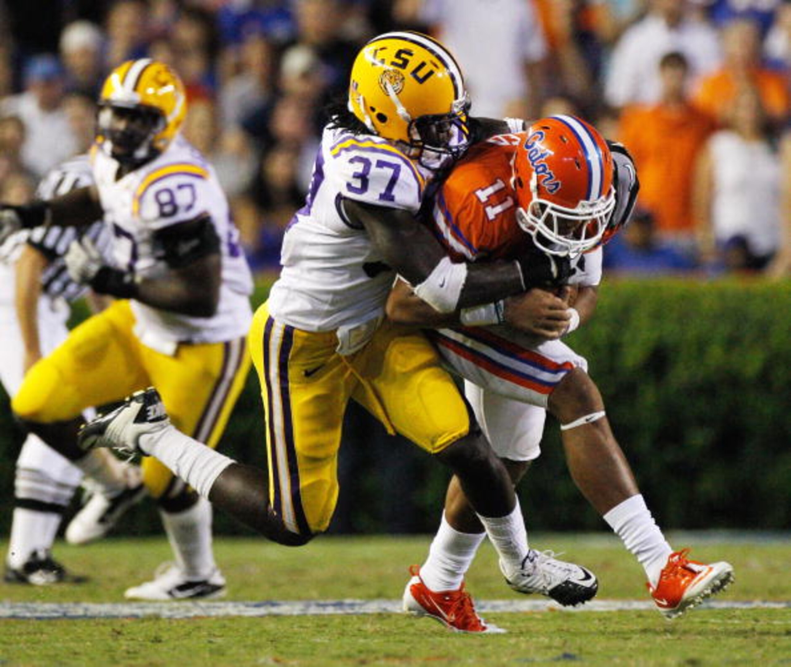 GAINESVILLE, FL - OCTOBER 09:  Karnell Hatcher #37 of the Louisiana State University Tigers tackles Jordan Reed #11 of the Florida Gators during the game at Ben Hill Griffin Stadium on October 9, 2010 in Gainesville, Florida.  (Photo by Sam Greenwood/Gett