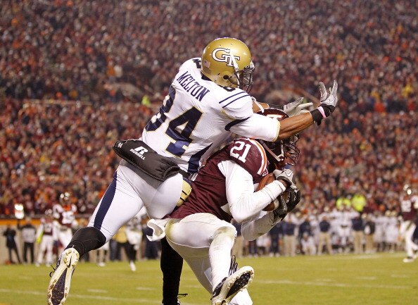 BLACKSBURG, VA - NOVEMBER 04:  Cornerback Rashad Carmichael #21 of the Virginia Tech Hokies intercepts a pass in the end zone in the final seconds intended for wide receiver Tyler Melton #84 of the Georgia Tech Yellow Jackets at Lane Stadium on November 4