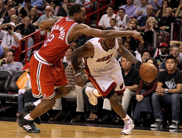 MIAMI, FL - APRIL 06:  Lebron James #6 of the Miami Heat is guarded by Luc Mbah a Moute #12 of the Milwaukee Bucks during a game at American Airlines Arena on April 6, 2011 in Miami, Florida. NOTE TO USER: User expressly acknowledges and agrees that, by d