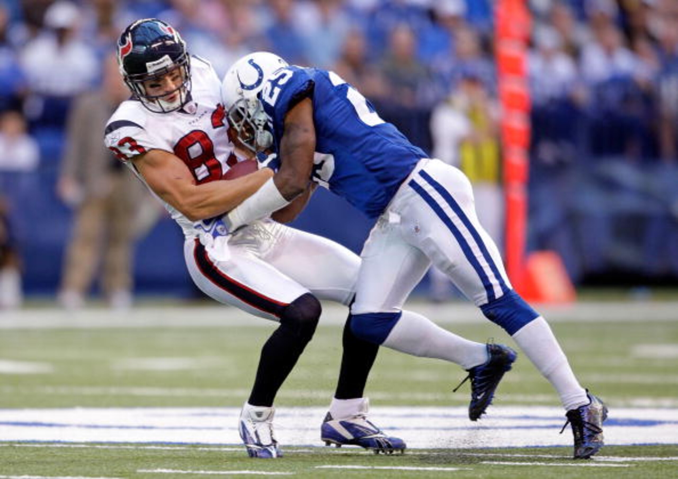 INDIANAPOLIS - NOVEMBER 8:  Kevin Walter #83 of the  Houston Texans runs with the ball while tackled by Jerraud Powers #25 of the Indianapolis Colts during the NFL game at Lucas Oil Stadium on November 8, 2009 in Indianapolis, Indiana.  The Colts defeated