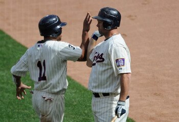 MINNEAPOLIS, MN - JUNE 11: Ben Revere #11 and Michael Cuddyer #5 of the Minnesota Twins celebrate Revere scoring against the Texas Rangers during the fourth inning of their game on June 11, 2011 at Target Field in Minneapolis, Minnesota. The Twins defeate MINNEAPOLIS, MN - JUNE 11: Ben Revere #11 and Michael Cuddyer #5 of the Minnesota Twins celebrate Revere scoring against the Texas Rangers during the fourth inning of their game on June 11, 2011 at Target Field in Minneapolis, Minnesota. The Twins defeate