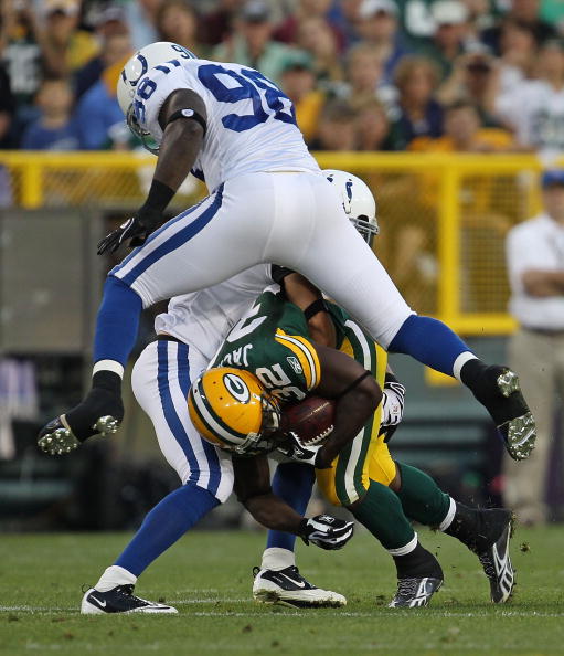 GREEN BAY, WI - AUGUST 26: Brandon Jackson #32 of the Green Bay Packers is brought down by Robert Mathis #98 and Melvin Bullitt #33 of the Indianapolis Colts during a preseason game at Lambeau Field on August 26, 2010 in Green Bay, Wisconsin. (Photo by Jo