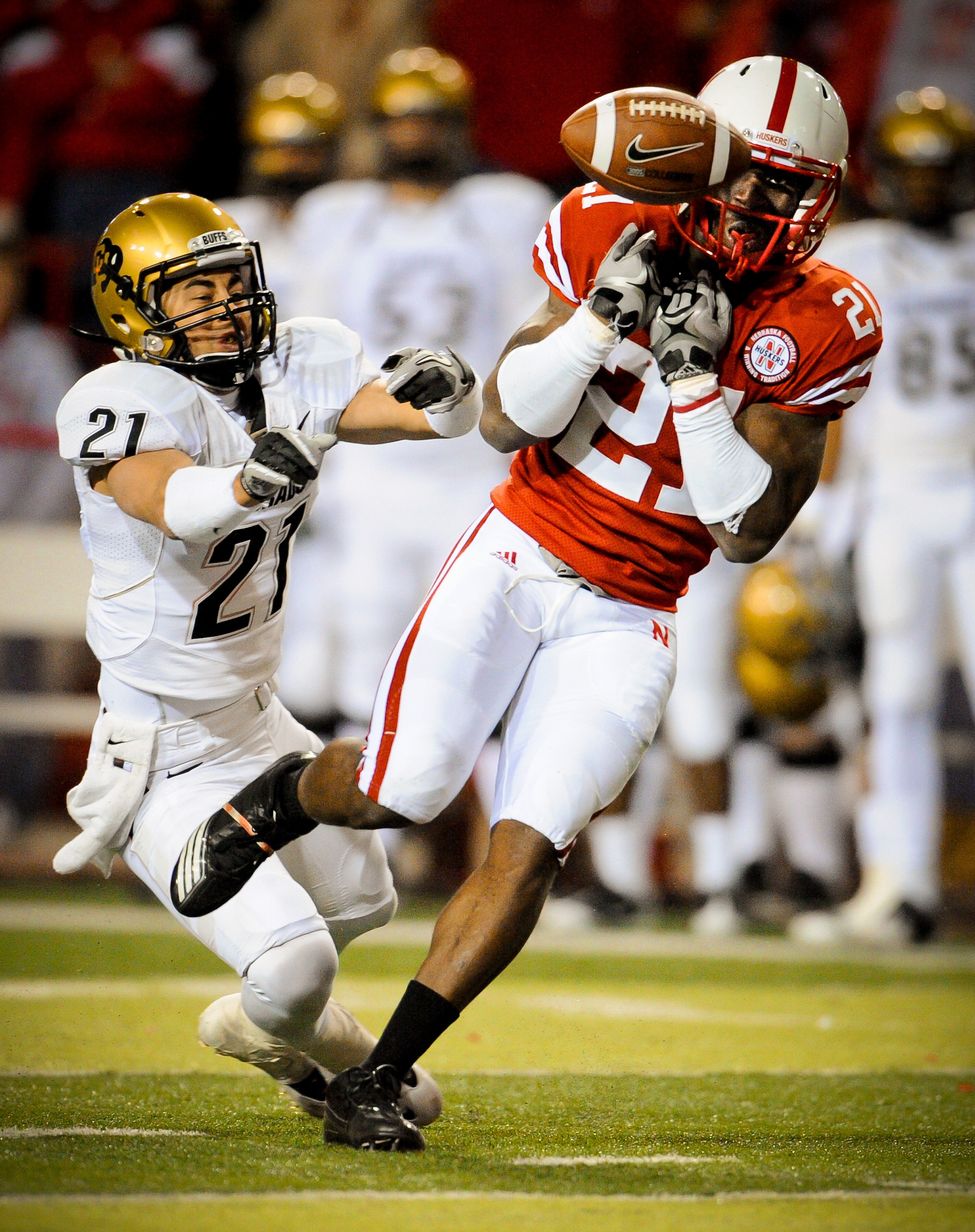 LINCOLN, NE - NOVEMBER 26: Prince Amukamara #21 of the Nebraska Cornhuskers misses a chance at an interception from Scotty McKnight #21 of the Colorado Buffaloes during the second half of their game at Memorial Stadium on November 26, 2010 in Lincoln, Neb