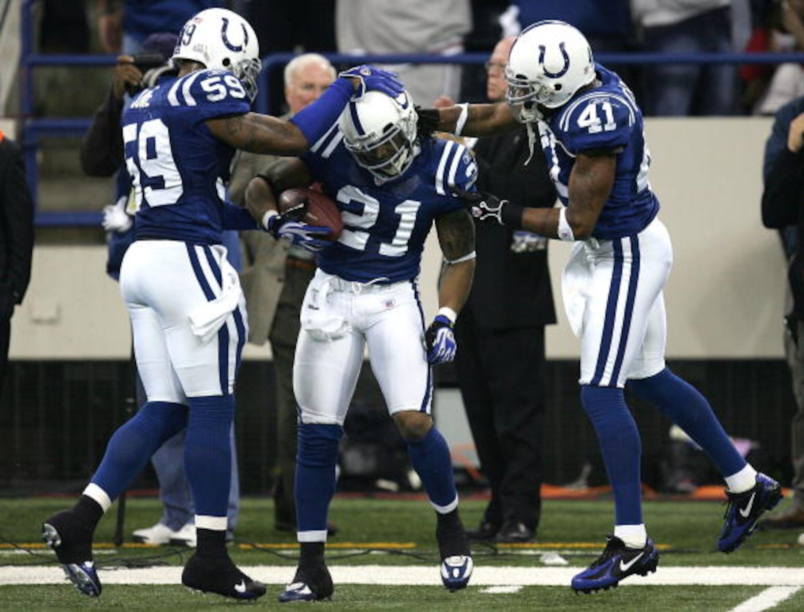 INDIANAPOLIS - JANUARY 06:  (L-R) Cato June #59, Bob Sanders #21 and Antoine Bethea #41 of the Indianapolis Colts celebrate Sanders interception in the fourth quarter against the Kansas City Chiefs during their AFC Wild Card Playoff Game January 6, 2007 a