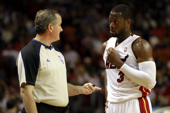 MIAMI, FL - MARCH 27:  Guard Dwyane Wade of the Miami Heat chats with the referee against the Houston Rockets at American Airlines Arena on March 27, 2011 in Miami, Florida. NOTE TO USER: User expressly acknowledges and agrees that, by downloading and/or