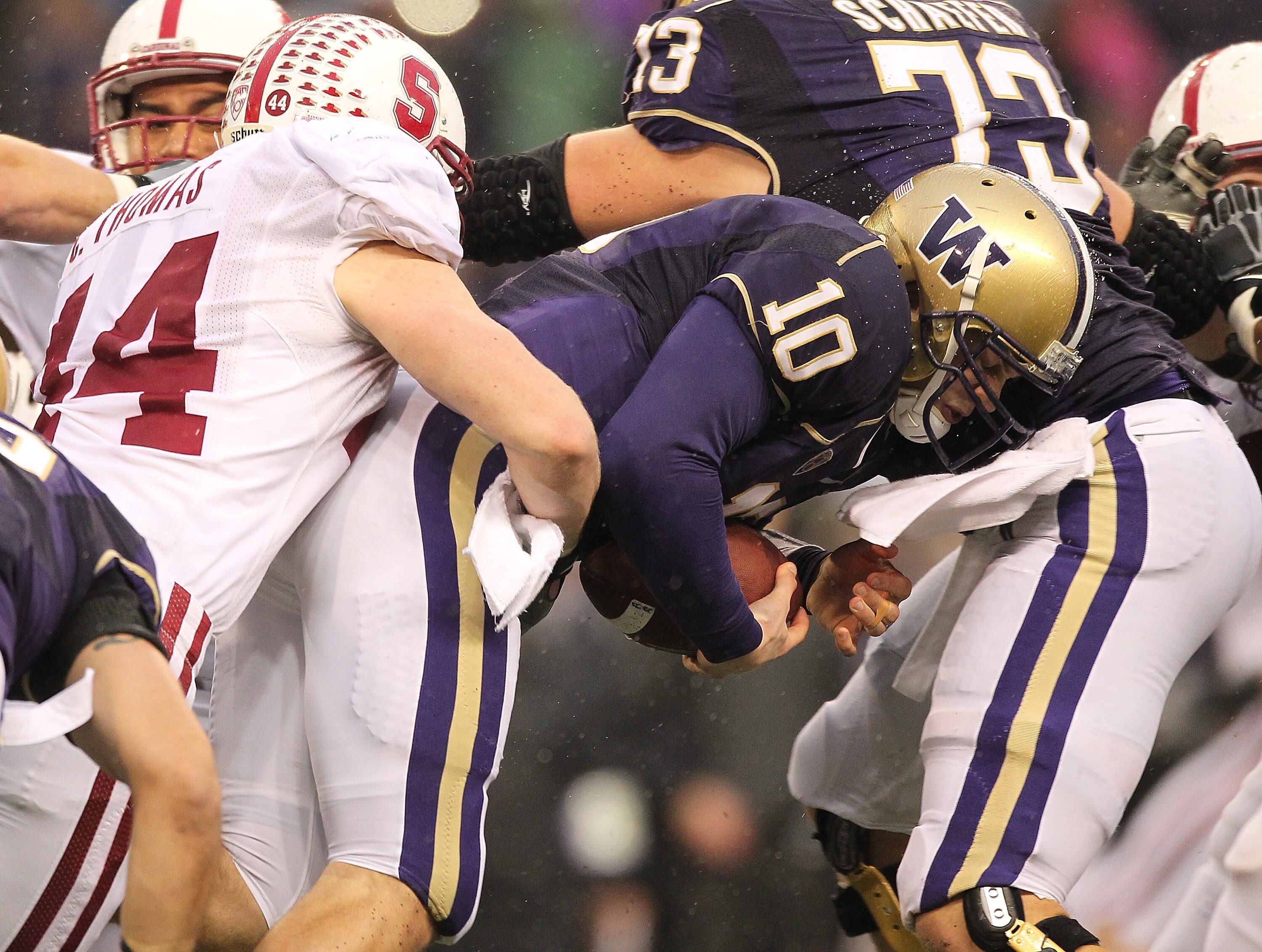 SEATTLE - OCTOBER 30:  Quarterback Jake Locker #10 of the Washington Huskies is tackled by Chase Thomas #44 of the Stanford Cardinal on October 30, 2010 at Husky Stadium in Seattle, Washington. (Photo by Otto Greule Jr/Getty Images)
