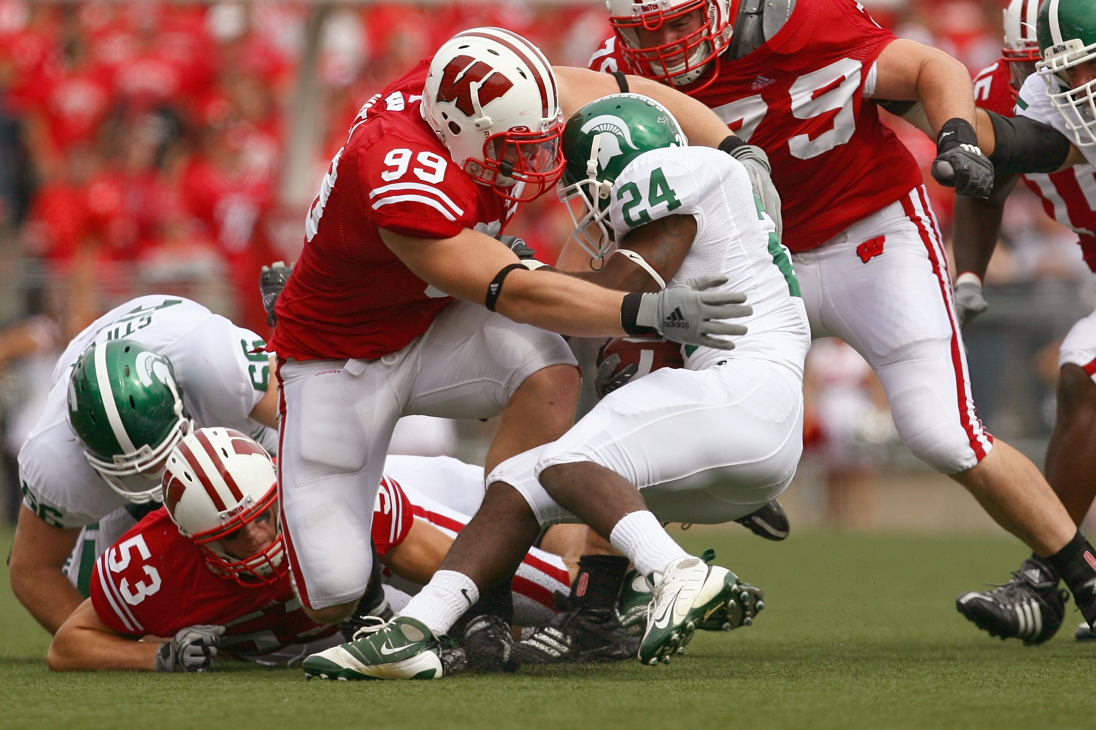 MADISON, WI - SEPTEMBER 26: J.J. Watt #99 of the Wisconsin Badgers tackles Caulton Ray #24 of the Michigan State Spartans on September 26, 2009 at Camp Randall Stadium in Madison, Wisconsin. Wisconsin defeated Michigan State 38-30. (Photo by Jonathan Dani