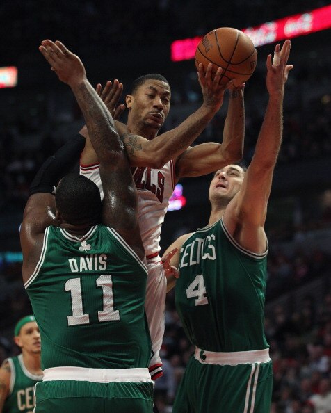 CHICAGO, IL - APRIL 07: Derrick Rose #1 of the Chicago Bulls is called for a charge as he attempts to drive against Glen Davis #11 and Nenad Krstic #4 of the Boston Celtics at United Center on April 7, 2011 in Chicago, Illinois. The Bulls defeated the Cel