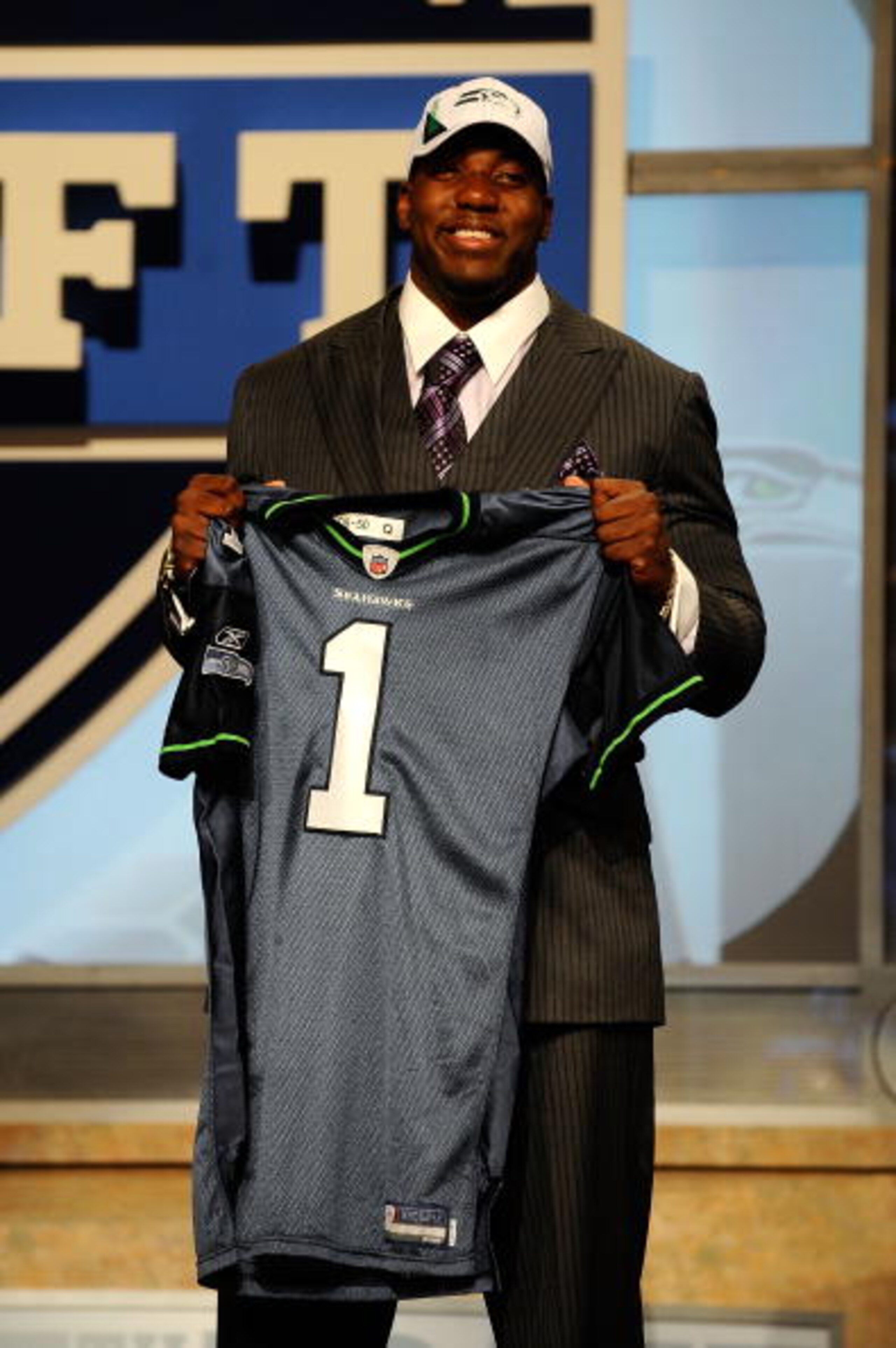 NEW YORK - APRIL 22:  Russell Okung from the Oklahoma State Cowboys holds a Seattle Seahawks jersey after he was selected #6 overall by the Seahawks in the first round during the 2010 NFL Draft at Radio City Music Hall on April 22, 2010 in New York City.