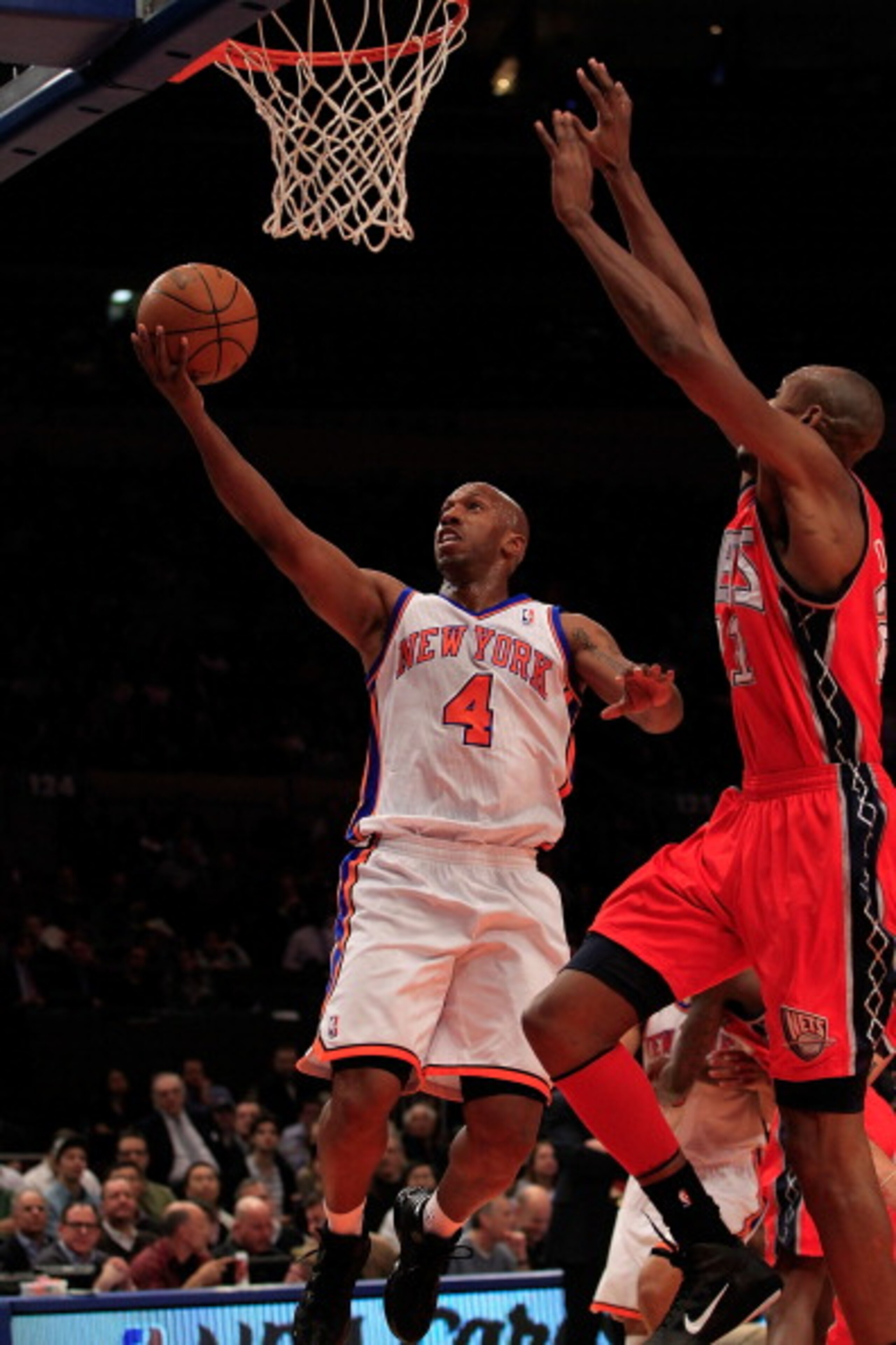 NEW YORK, NY - MARCH 30: Chauncey Billups #4 of the New York Knicks shoots over Travis Outlaw#21 of the New Jersey Nets at Madison Square Garden on March 30, 2011 in New York City. NOTE TO USER: User expressly acknowledges and agrees that, by downloading 
