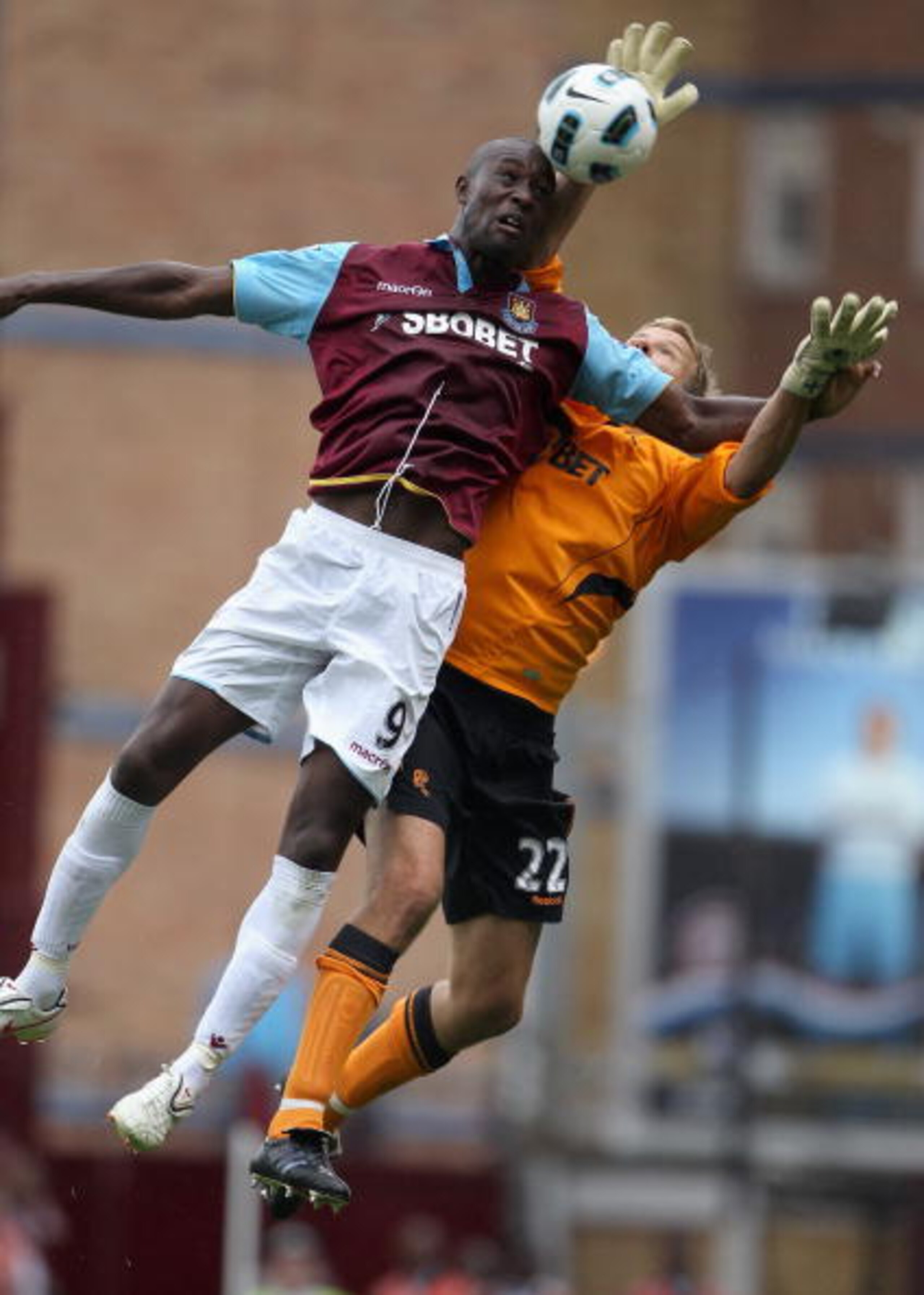 LONDON, ENGLAND - AUGUST 21:  Carlton Cole of West Ham United and Jussi Jaaskelainen of Bolton Wanderers jump for the ball during the Barclays Premier League match between West Ham United and Bolton Wanderers at the Boleyn Ground on August 21, 2010 in Lon