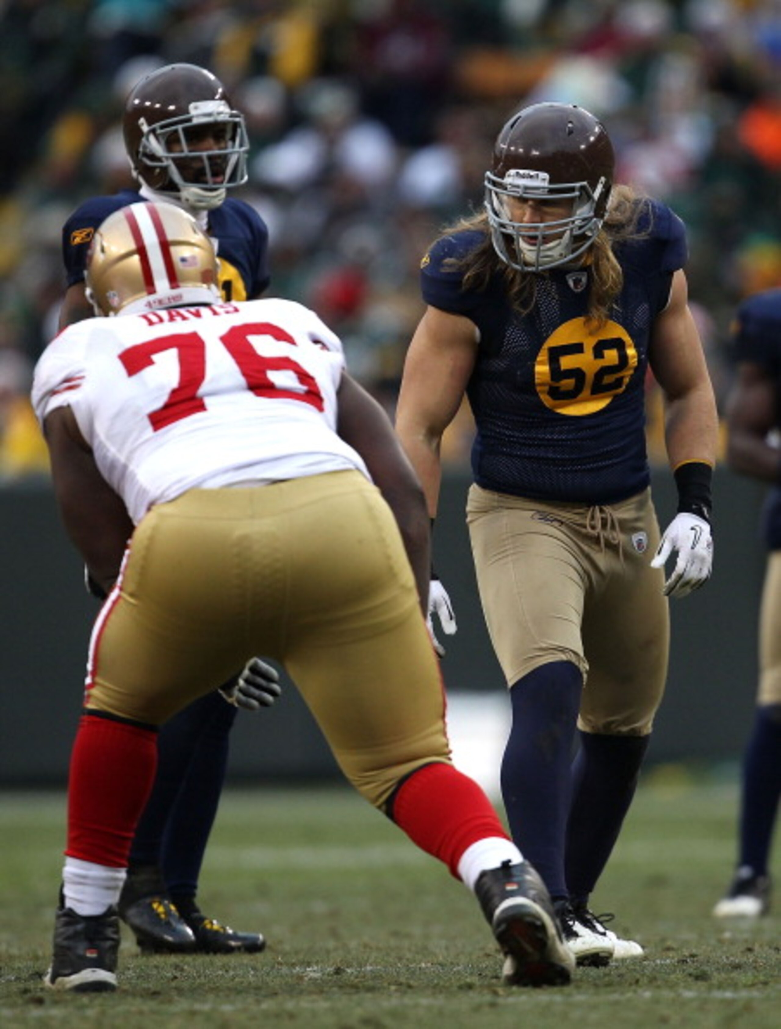 GREEN BAY, WI - DECEMBER 05: Clay Matthews #52 of the Green Bay Packers prepares to rush against Anthony Davis #76 of the San Francisco 49ers at Lambeau Field on December 5, 2010 in Green Bay, Wisconsin. The Packers defeated the 49ers 34-16.  (Photo by Jo