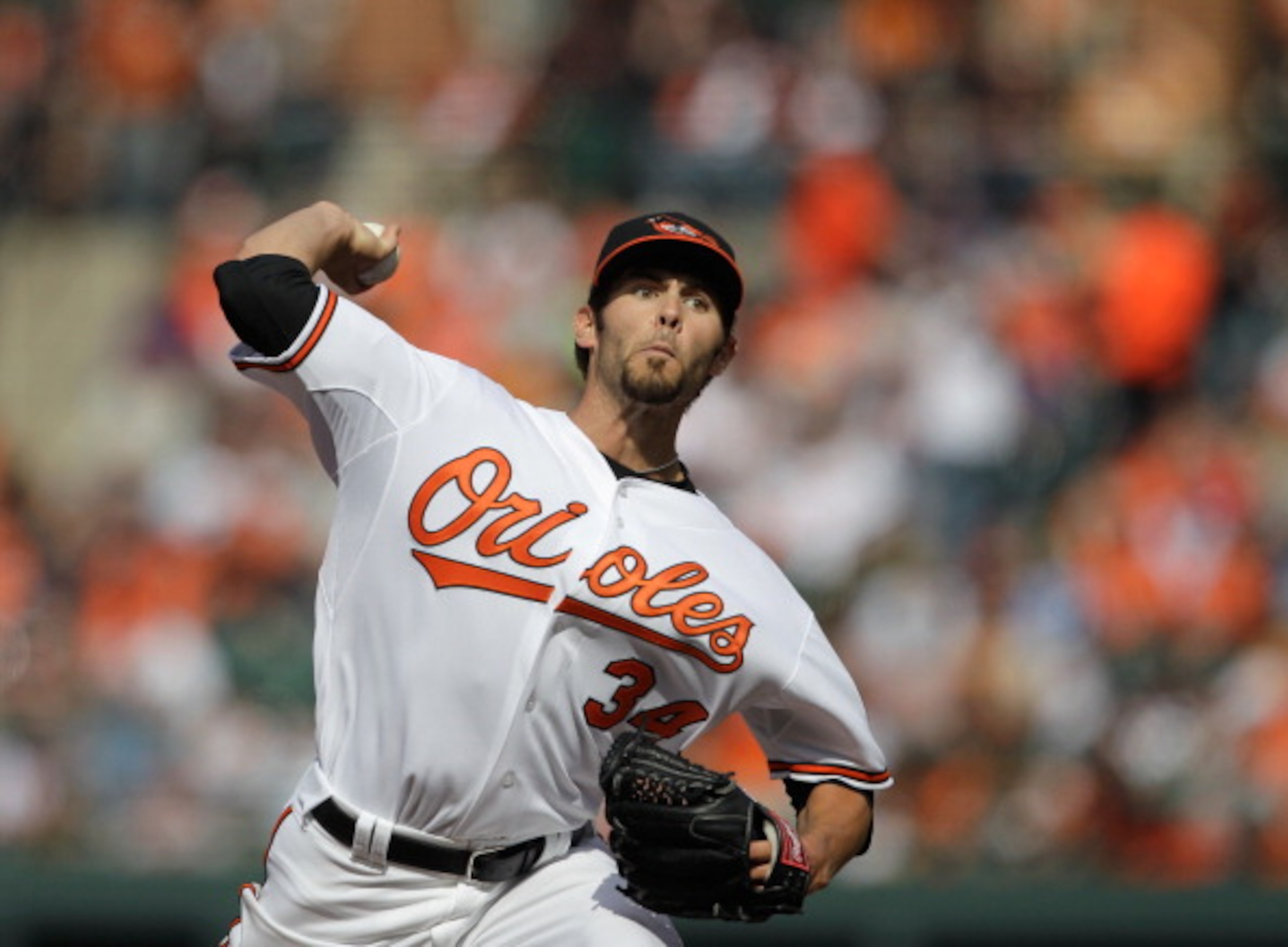 BALTIMORE, MD - APRIL 04:  Starting pitcher Jake Arrieta #34 of the Baltimore Orioles delivers to a Detroit Tigers batter during the second inning during opening day at Oriole Park at Camden Yards on April 4, 2011 in Baltimore, Maryland.  (Photo by Rob Ca
