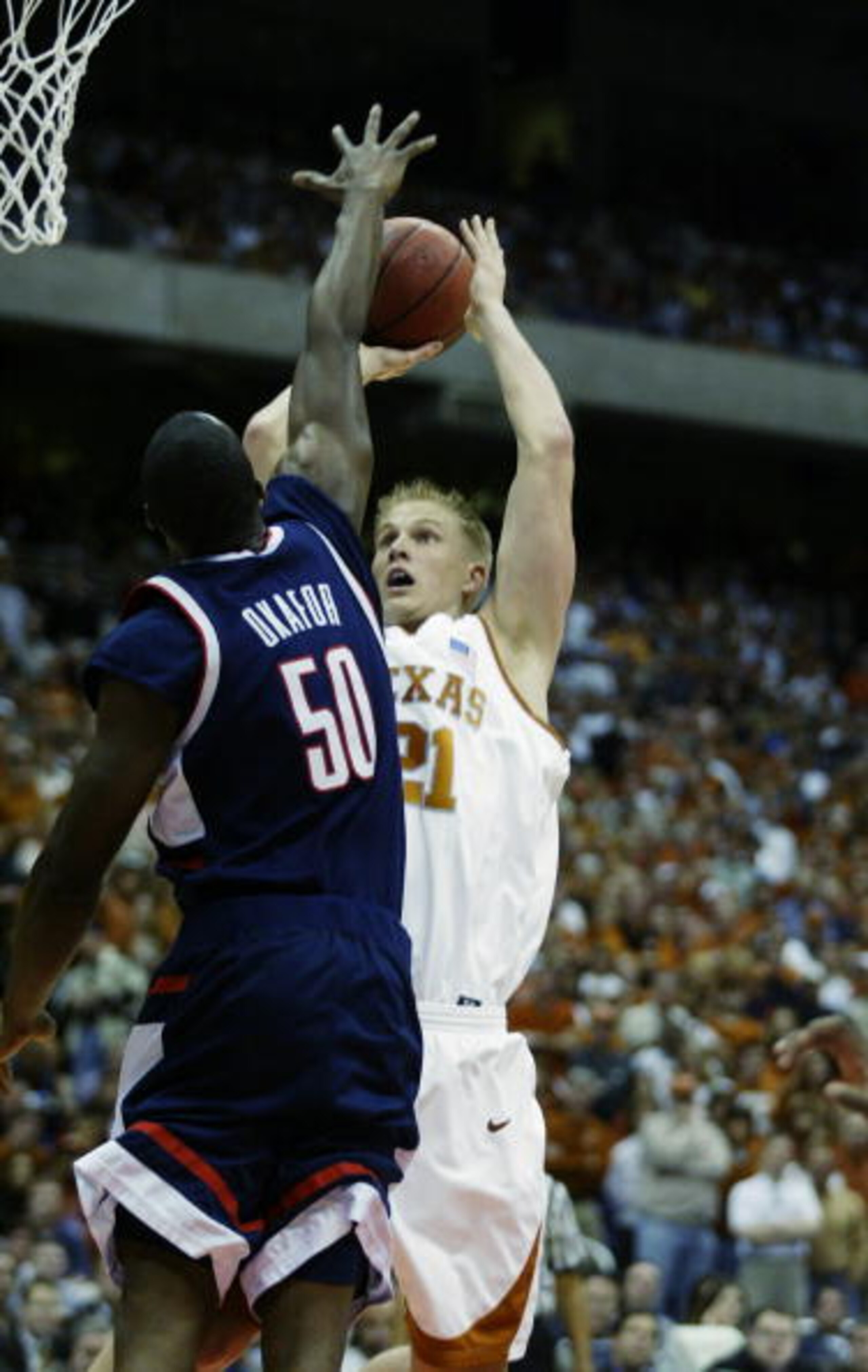 SAN ANTONIO - MARCH 28:  Jason Klotz #21 of the University of Texas Longhorns shoots over Emeka Okafor #50 of the University of Connecticut Huskies during the south regional semifinals of the NCAA Division I Men's Tournament at the Alamodome on March 28, 