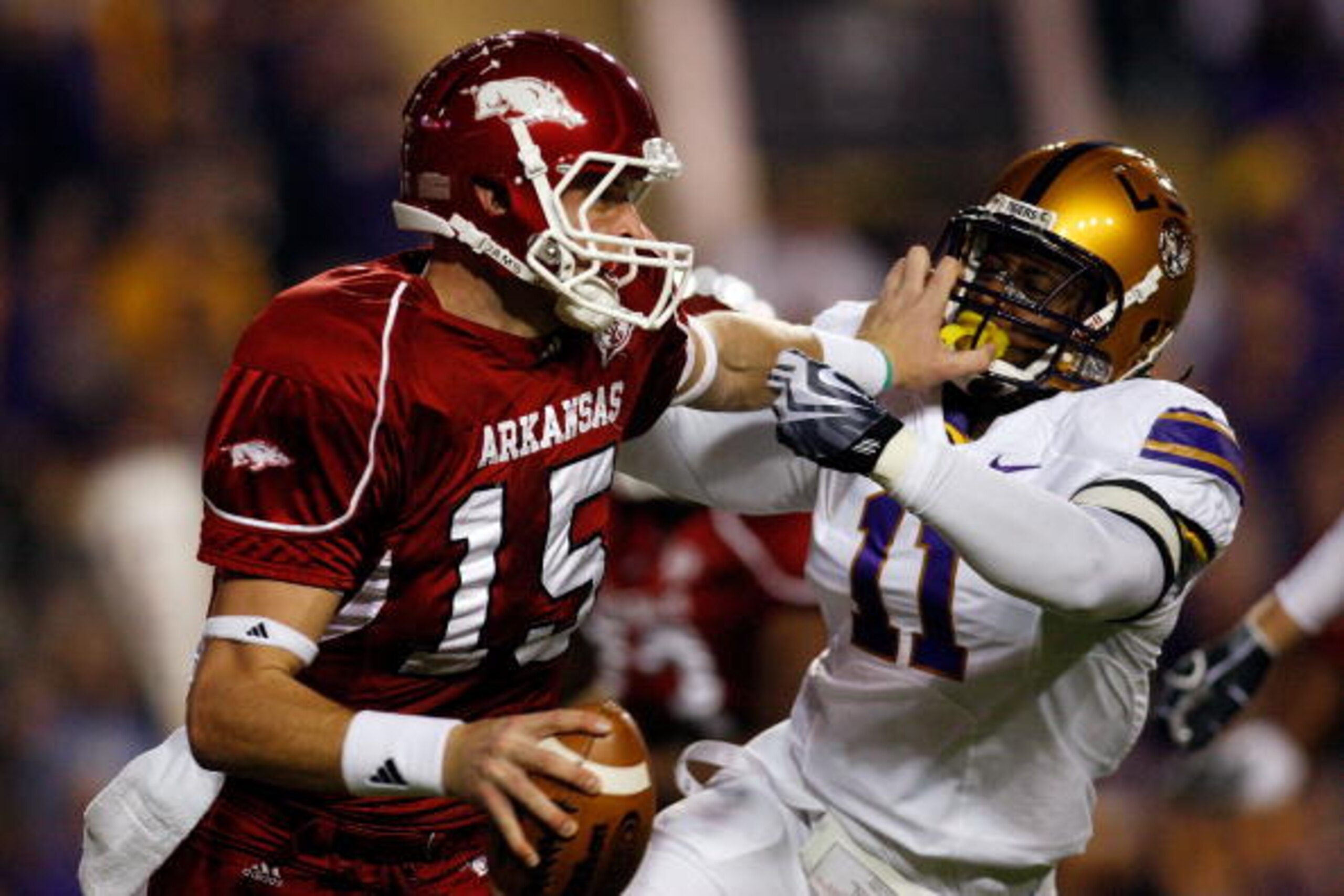 BATON ROUGE, LA - NOVEMBER 28: Quarterback Ryan Mallett #15 of the Arkansas Razorbacks avoids a tackle by Kelvin Sheppard #11 of the Louisiana State University Tigers at Tiger Stadium on November 28, 2009 in Baton Rouge, Louisiana. (Photo by Chris Grayt BATON ROUGE, LA - NOVEMBER 28: Quarterback Ryan Mallett #15 of the Arkansas Razorbacks avoids a tackle by Kelvin Sheppard #11 of the Louisiana State University Tigers at Tiger Stadium on November 28, 2009 in Baton Rouge, Louisiana. (Photo by Chris Grayt