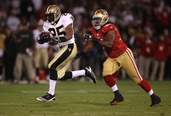 SAN FRANCISCO - SEPTEMBER 20:  Reggie Bush #25 of the New Orleans Saints runs against Ray McDonald #91 of the San Francisco 49ers during an NFL game at Candlestick Park on September 20, 2010 in San Francisco, California.  (Photo by Jed Jacobsohn/Getty Ima