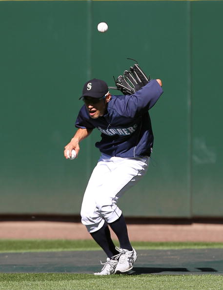 SEATTLE - JULY 24:  Right fielder Ichiro Suzuki #51 of the Seattle Mariners makes a behind-the-back catch during batting practice prior to the game against the Boston Red Sox at Safeco Field on July 24, 2010 in Seattle, Washington. (Photo by Otto Greule J