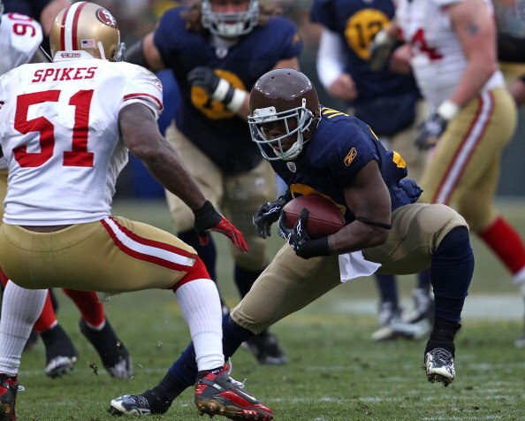 GREEN BAY, WI - DECEMBER 05: Brandon Jackson #32 of the Green Bay Packers moves against Takeo Spikes #51 of the San Francisco 49ers at Lambeau Field on December 5, 2010 in Green Bay, Wisconsin. The Packers defeated the 49ers 34-16. (Photo by Jonathan Dani