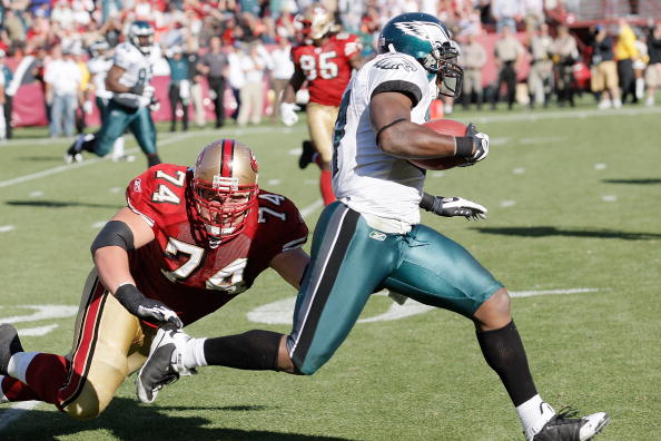SAN FRANCISCO - OCTOBER 12:  Defensive back Quentin Mikell #27 of the Philadelphia Eagles returns an interception as offensive lineman Joe Staley #74 of the San Francisco 49ers tries to stop him on October 12, 2008 at Candlestick Park in San Francisco, Ca