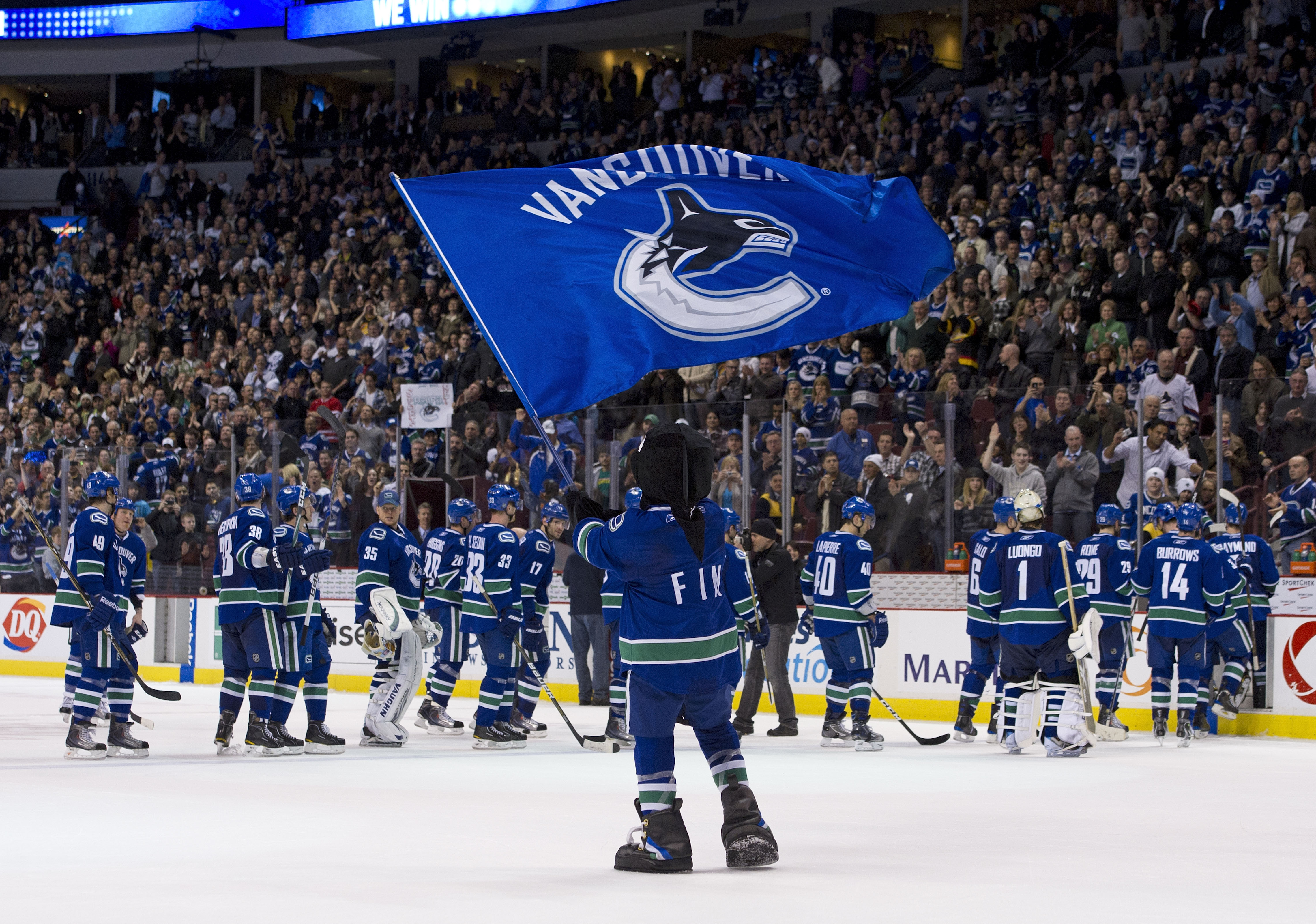 VANCOUVER, CANADA - MARCH 31: Vancouver Canucks mascot Fin waves a team flag after the Vancouver Canucks defeated the Los Angeles Kings in NHL action on March 31, 2011 at Rogers Arena in Vancouver, BC, Canada.  (Photo by Rich Lam/Getty Images)