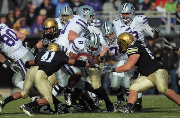 BOULDER, CO - NOVEMBER 20:  Daniel Thomas #8 of the Kansas State Wildcats rushes with the ball as Terrel Smith #41 and Will Pericak #83 of the Colorado Buffaloes close in for the tackle at Folsom Field on November 20, 2010 in Boulder, Colorado. Colorado d