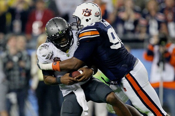 GLENDALE, AZ - JANUARY 10:  Quarterback Darron Thomas #1 of the Oregon Ducks is sacked by Nick Fairley #90 of the Auburn Tigers in the first half in the Tostitos BCS National Championship Game at University of Phoenix Stadium on January 10, 2011 in Glenda