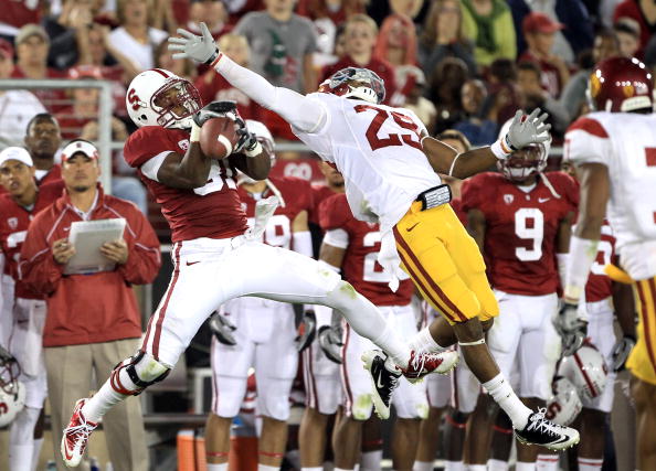 PALO ALTO, CA - OCTOBER 09:  Chris Owusu #81 of the Stanford Cardinal catches a ball over the outstreched arms of Jawanza Starling #29 of the USC Trojans at Stanford Stadium on October 9, 2010 in Palo Alto, California.  (Photo by Ezra Shaw/Getty Images)