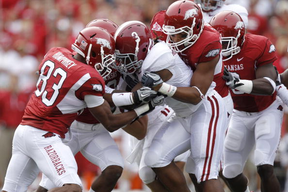 FAYETTEVILLE - SEPTEMBER 25: Trent Richardson #3 of the Alabama Crimson Tide gets tackled by a group of Arkansas Razorbacks defenders during the first half at Donald W. Reynolds Razorback Stadium on September 25, 2010 in Fayetteville, Arkansas. (Photo by