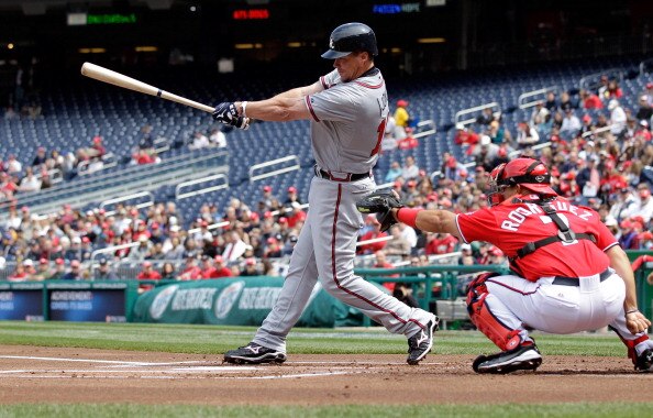 WASHINGTON, DC - APRIL 03: Catcher Ivan Rodriguez #7 of the Washington Nationals looks on a Chipper Jones #10 of the Atlanta Braves follows through on swing at Nationals Park on April 3, 2011 in Washington, DC.  (Photo by Rob Carr/Getty Images)