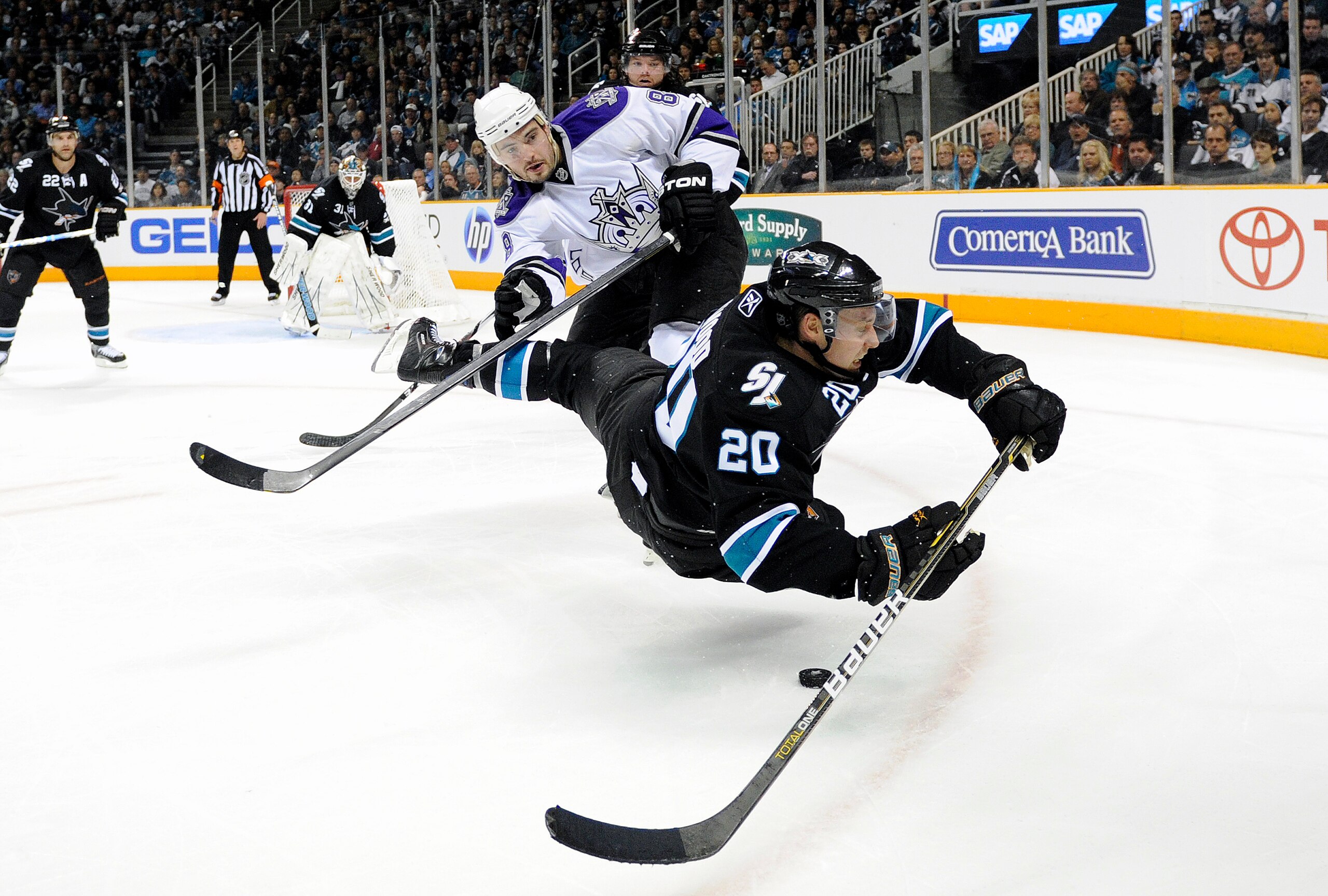 SAN JOSE, CA - APRIL 14: Drew Doughty #8 of the Los Angeles Kings gets a penalty call for tripping Kyle Wellwood #20 of the San Jose Sharks in Game One of the Western Conference Quarterfinals  during the 2011 NHL Stanley Cup Playoffs at the HP Pavilion on